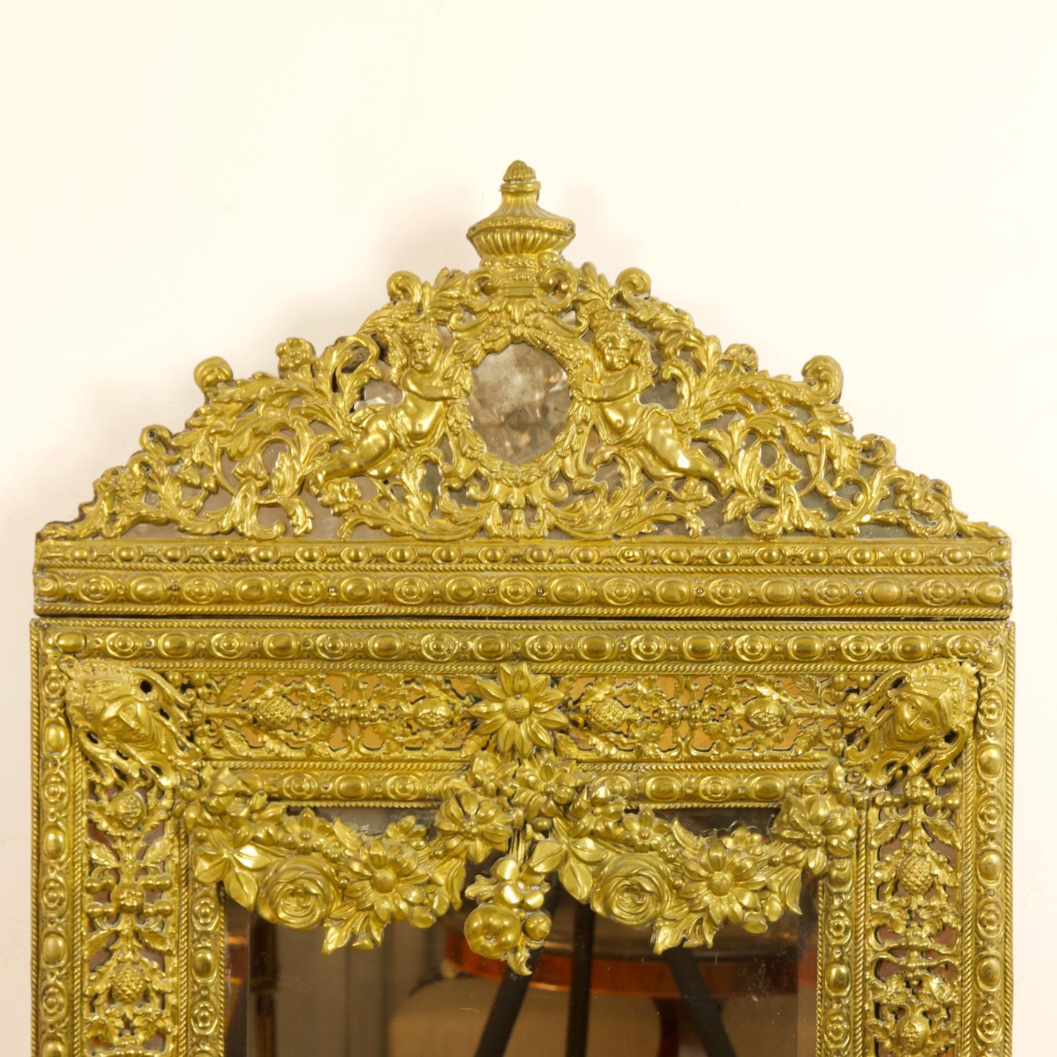 19th century Dutch Louis XIV Baroque style brass Repoussé wall mirror

Rectangular beveled mirror plate surrounded by a broad Baroque style brass frame with intricate repoussé fruit and foliage decoration, the corners of the frame with Baroque