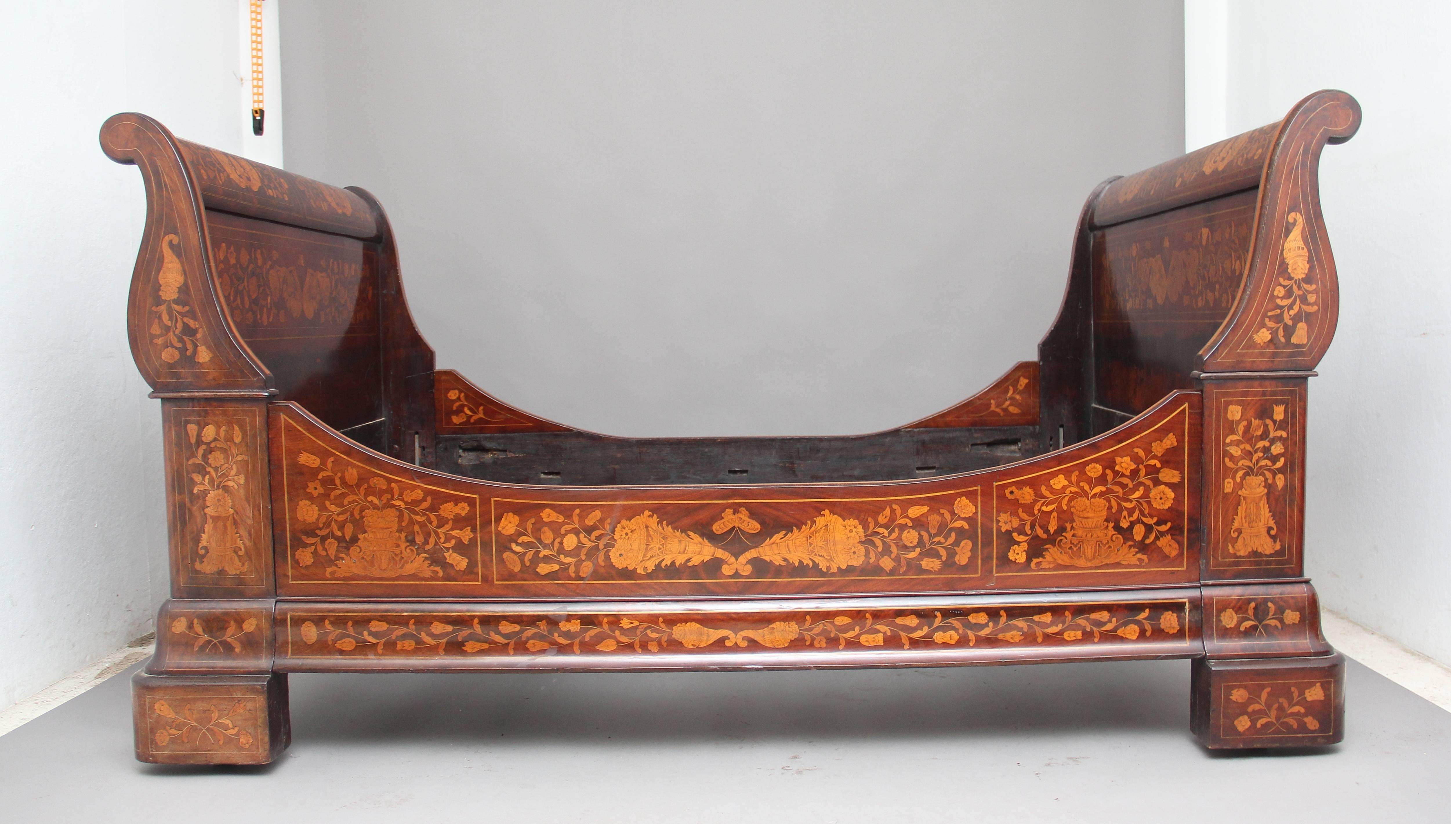 A superb quality early 19th century Dutch mahogany and marquetry sleigh bed, with scrolling head and footboards, profusely decorated all over, including the inside, with various floral marquetry, conforming stretchers, fantastic color and detail,