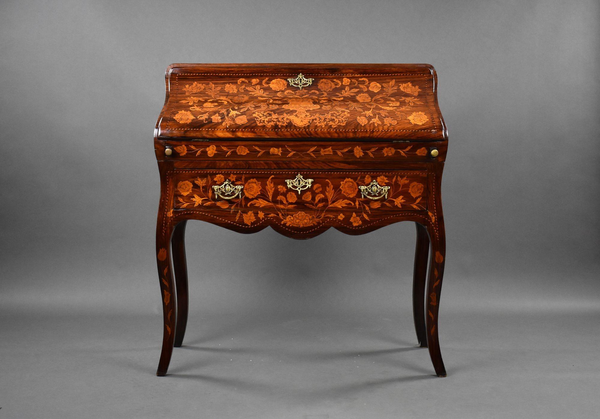For sale is an 19th century Dutch Marquetry Bureau. The sloping fall inlaid with flowers enclosing a shaped interior of drawers and pigeon holes. The bureau stands on nice cabriole legs and the top separates from the base for ease of transport.
