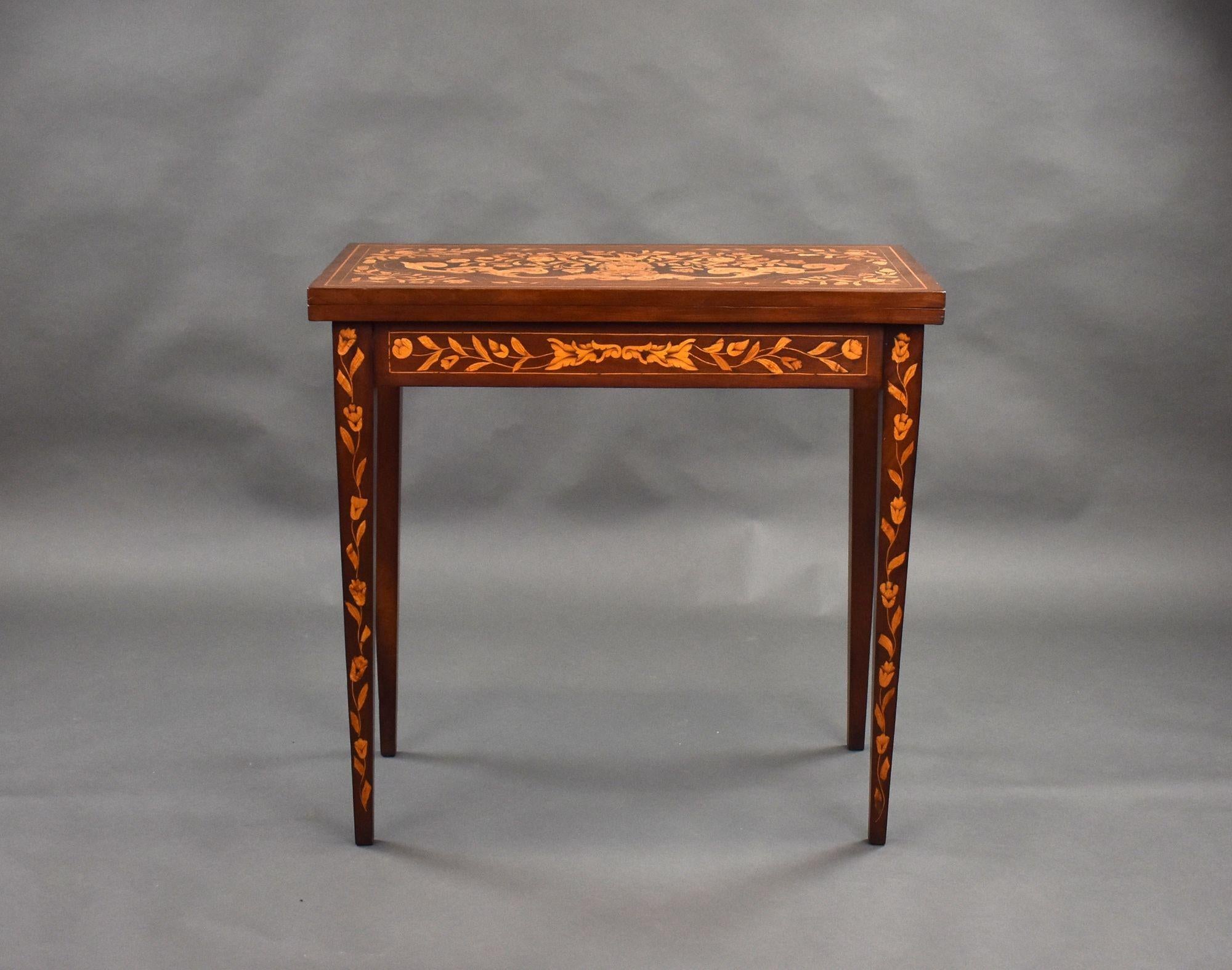 For sale is a good quality 19th century Dutch marquetry card table, profusely inlaid throughout, the top swivels and folds over to reveal a green playing surface along with further inlays depicting playing cards. The table stands on tapered legs and