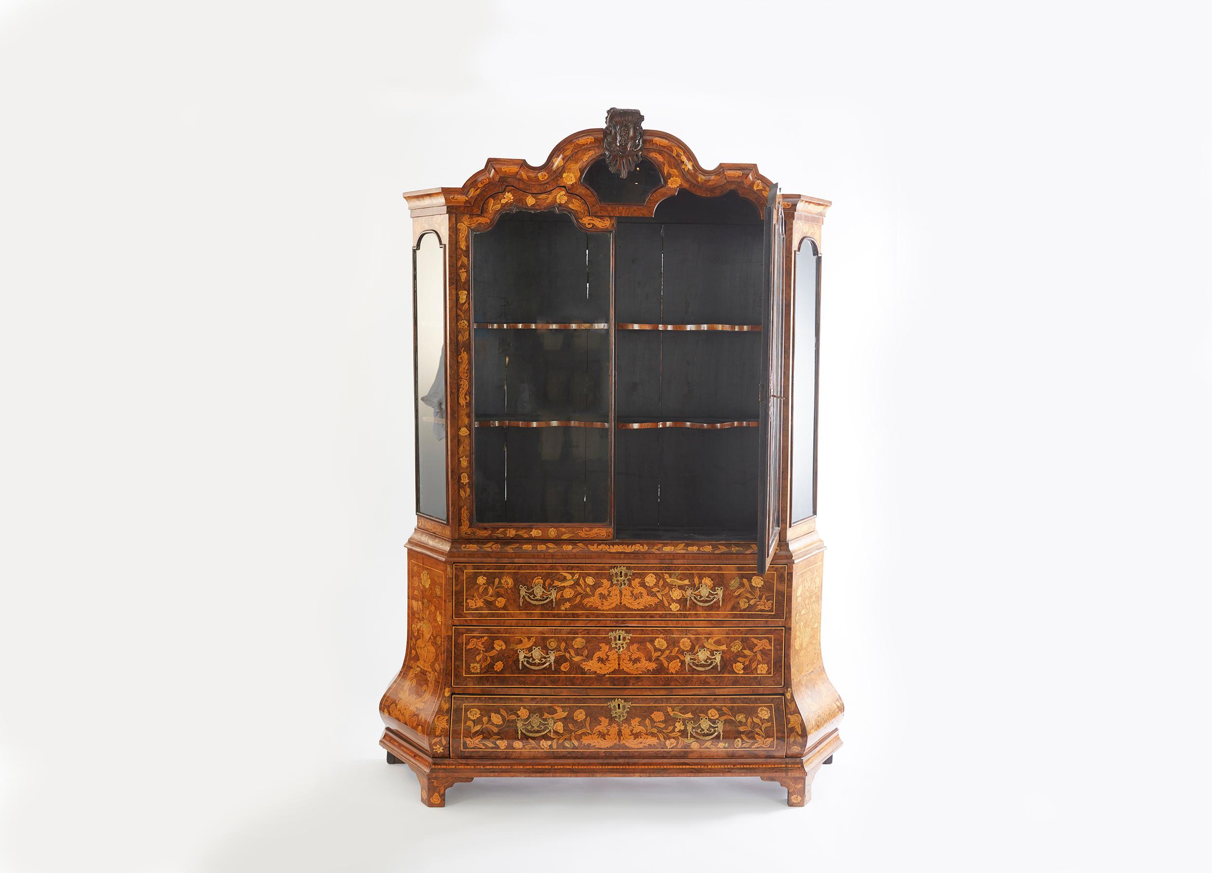 Very exquisite 19th century Dutch marquetry hand carved mahogany display cabinet. The cabinet is beautifully decorated with marquetry inlay including floral images, cherubs, birds and urns. The top section has 3 shelves for display and drawers down