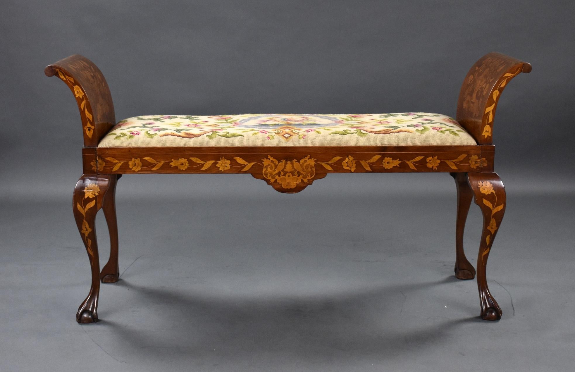 19th century Dutch marquetry window seat with scroll over ends inlaid with marquetry with urns flowers and birds, it has a drop in seat upholstered in floral tapestry. The seat is raised on cabriole legs terminating in elegant ball and claw feet.