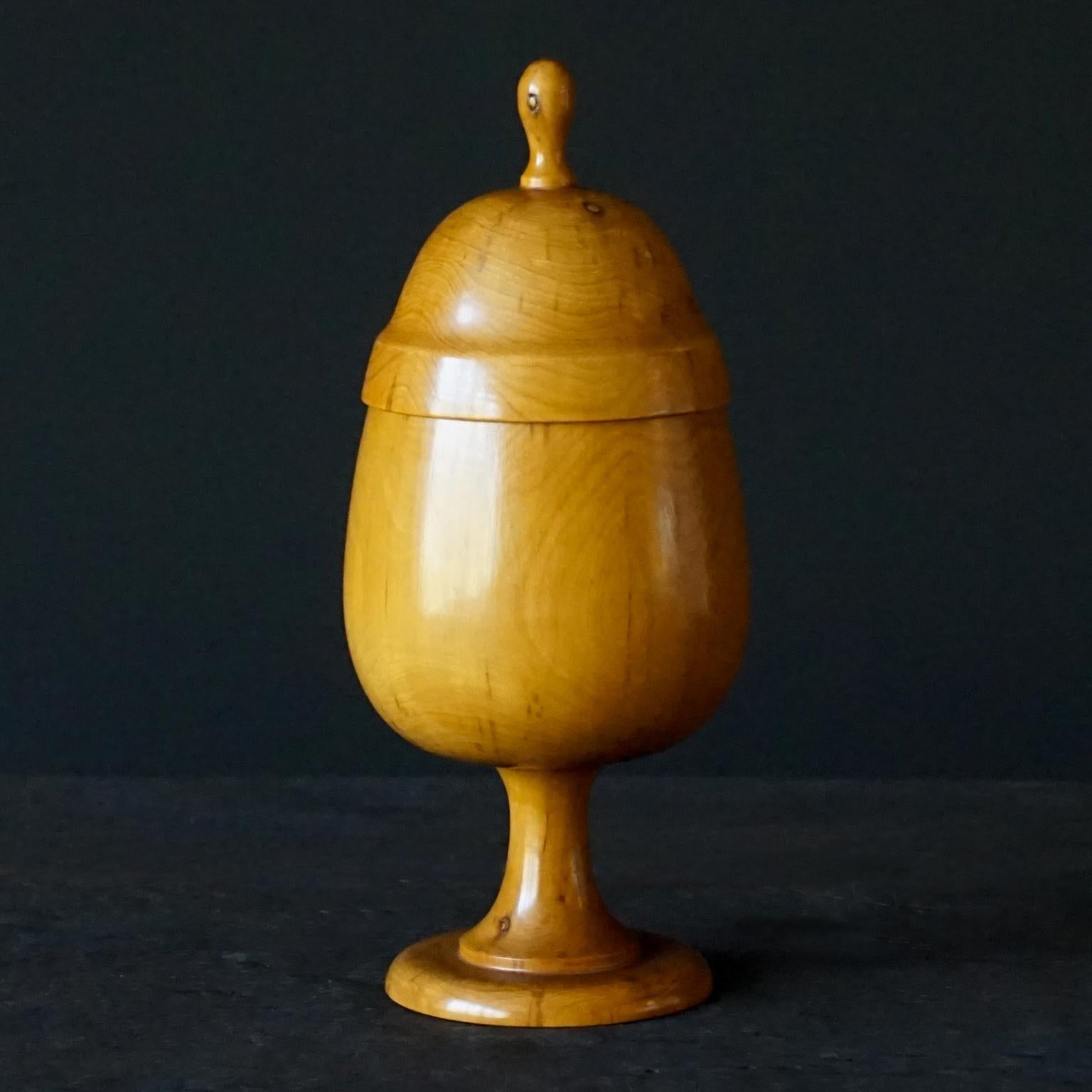 19th Century antique medical apothecary pharmacy turned treen boxwood pill gilder. 

Egg or aubergine shaped boxwood turned lidded cup on a stand.
The cup and stand are made from one piece of wood, so is the lid with knob.

Pill silverers or