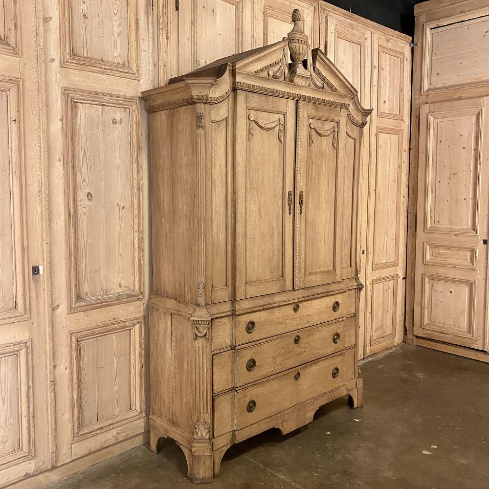 18th Century Dutch Neoclassical Wardrobe ~ Linen Press in Stripped Oak is a magnificent work created during the revival of classic Greek & Roman architecture during the mid-1800s.  The timeless facing arches with bold molded detail flank the focal