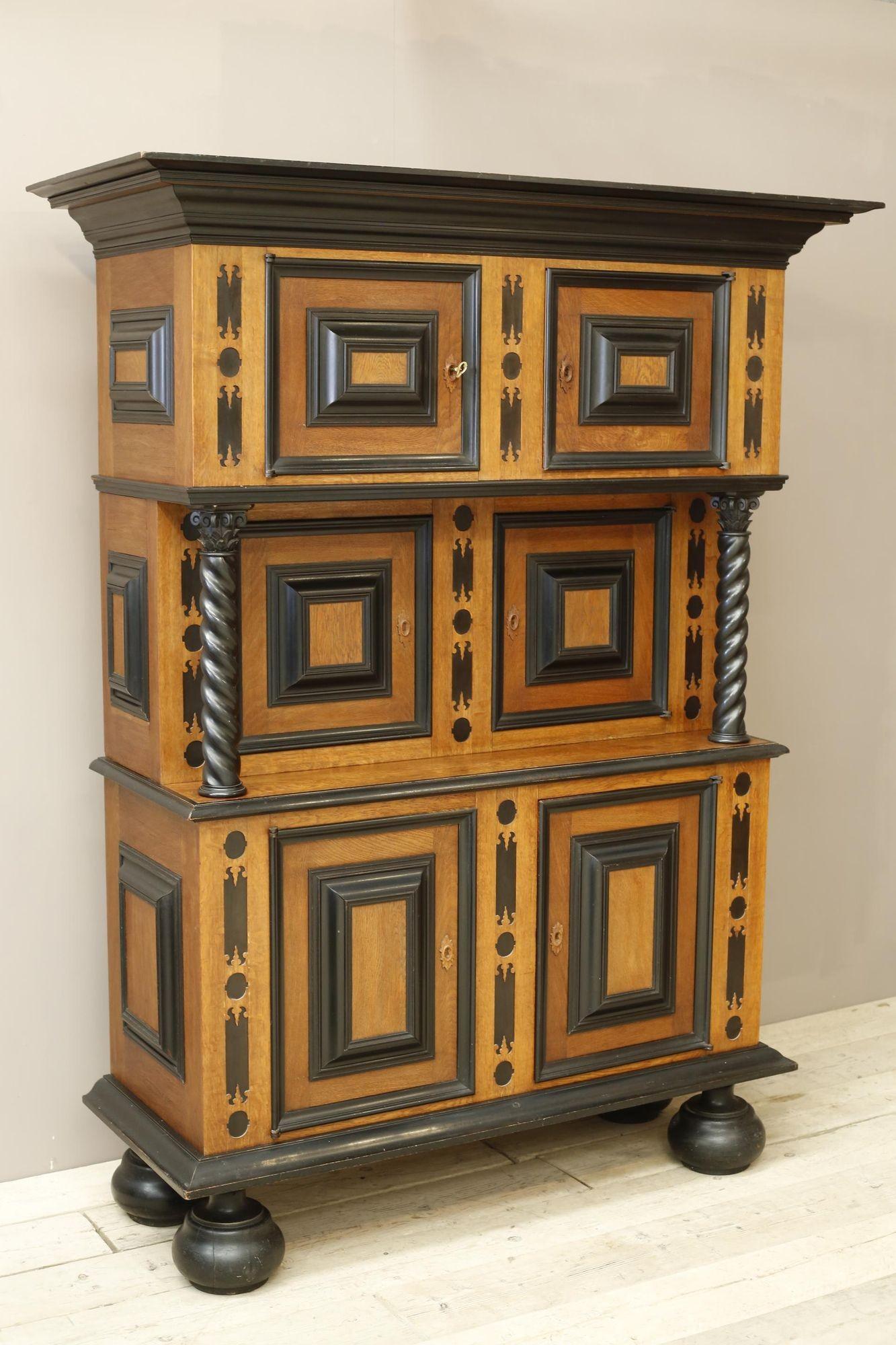 This is an incredibly striking 19th century Dutch cupboard. It is in 17th century style with a very impressive look. The whole piece is made from solid Oak with ebony and ebonised accents that set this piece off perfectly. The cupboard is in three