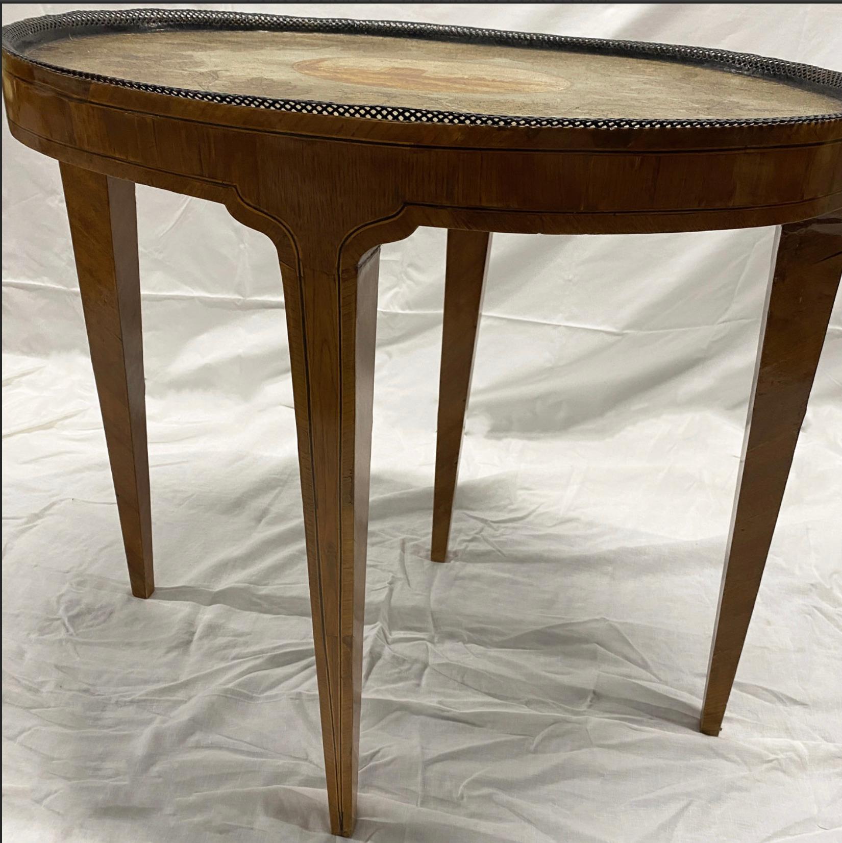 Oval table with tapered legs and landscape scene painted on top

Dimension: 29″L x 23″W x 30″H