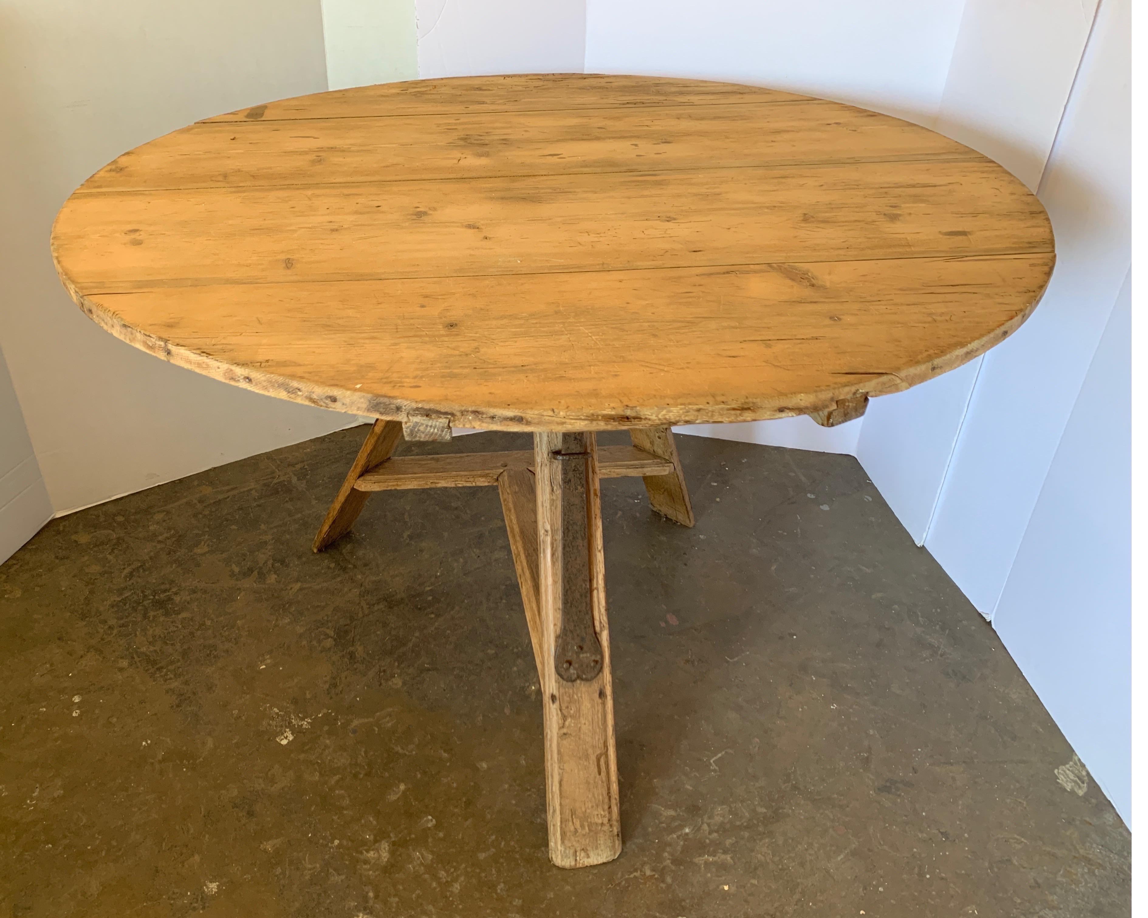 This is an unusual wine tasting table in Pine. It has amazing iron lever that hold the top in place. 
It’s great for a card table, breakfast or as it was meant for wine tasting. It originates from the Netherlands and is very sturdy.