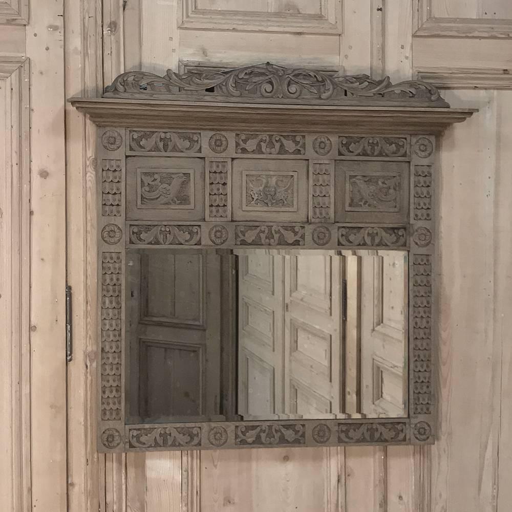 This charming antique Dutch Renaissance mirror has been carved across the entire facade by a talented rural artisan and features a pierce-carved crown plus birds, feathered panels and floral rosettes. Original bevelled mirror completes the