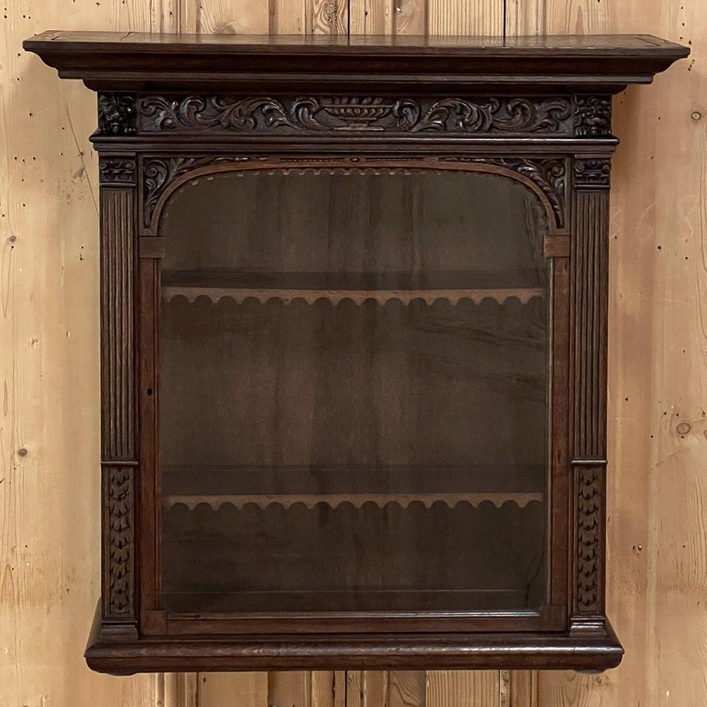 19th century Dutch Renaissance Wall Vitrine is perfect for keeping a collection of small valuable items dust-free and on full display! Hand-crafted from old-growth oak, it features a finely molded casework with a bold crown that also can serve as a