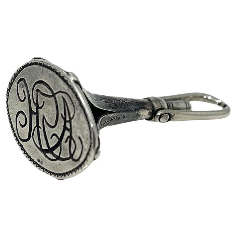 19th Century Dutch silver watch key and wax seal stamp

A Dutch wax seal stamp with initials (AH) in a trumpet shape with a watch key at the end. These wax seal stamps were worn on a chain with a hook to hang on clothing. (a chatelaine). The silver