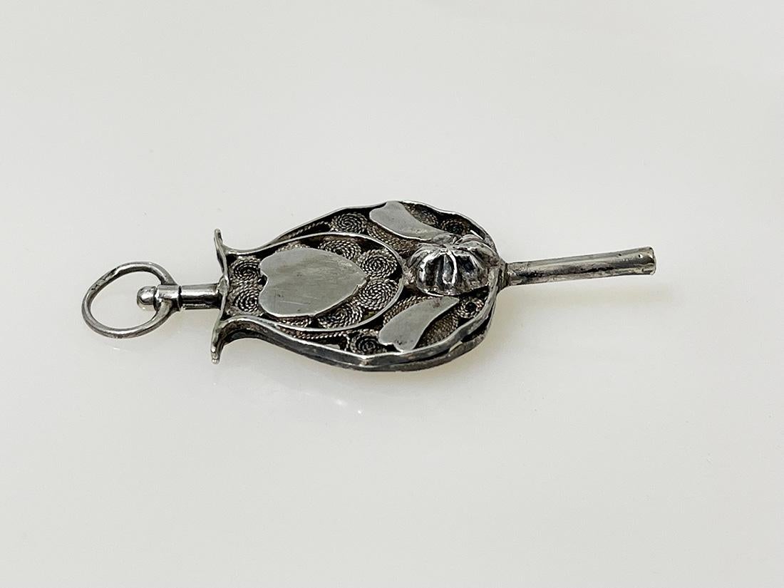 19th Century Dutch silver watch-key 

19th century silver watch-key in the shape of a musical instrument 
with filigree. The eyelet is marked but faded and probably it is the hallmark of Hendrik Krins. If it is this mark, than it is used between