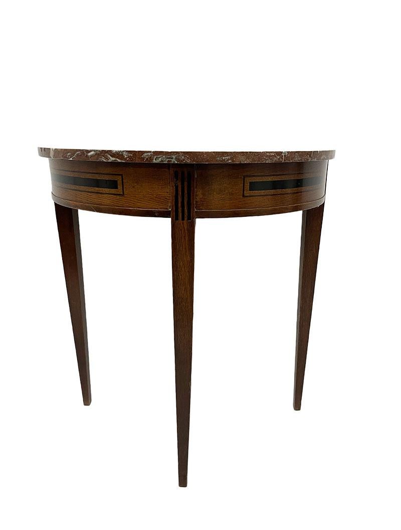 19th century Dutch small oak wall table, ca 1890

A 19th century Dutch wall table with marble top. A semi-circular model made of oak and ebony with a loose top of marble on 3 square tapered legs. In the curve of the table and the top of the leg