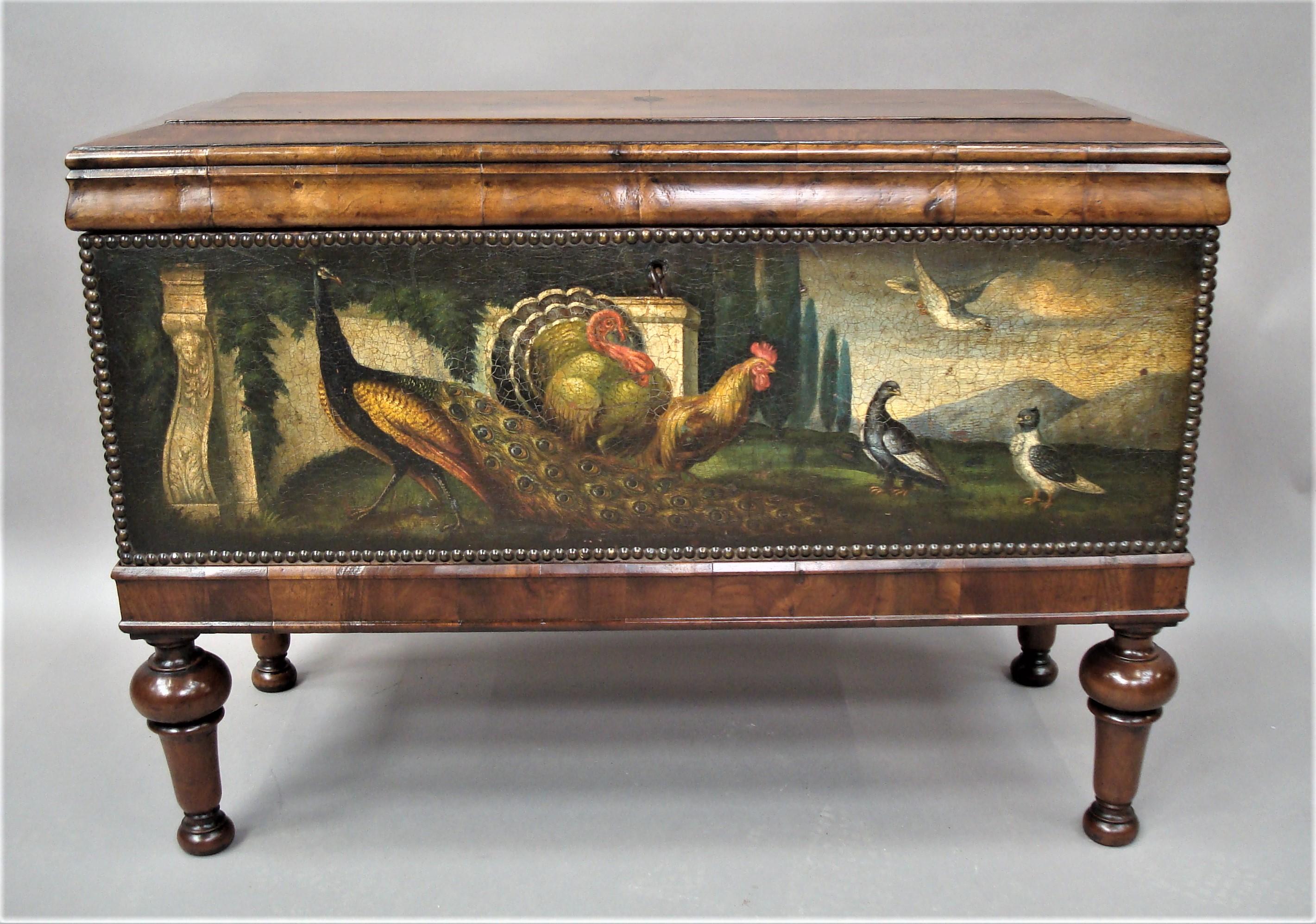 Impressive 19th century Dutch walnut and painted leather chest on stand; the well figured walnut lid with bookmatched raised panel top and wide crossbanded chamfered border above a bold gross grained ogee moulded frieze; the impressive oil painted