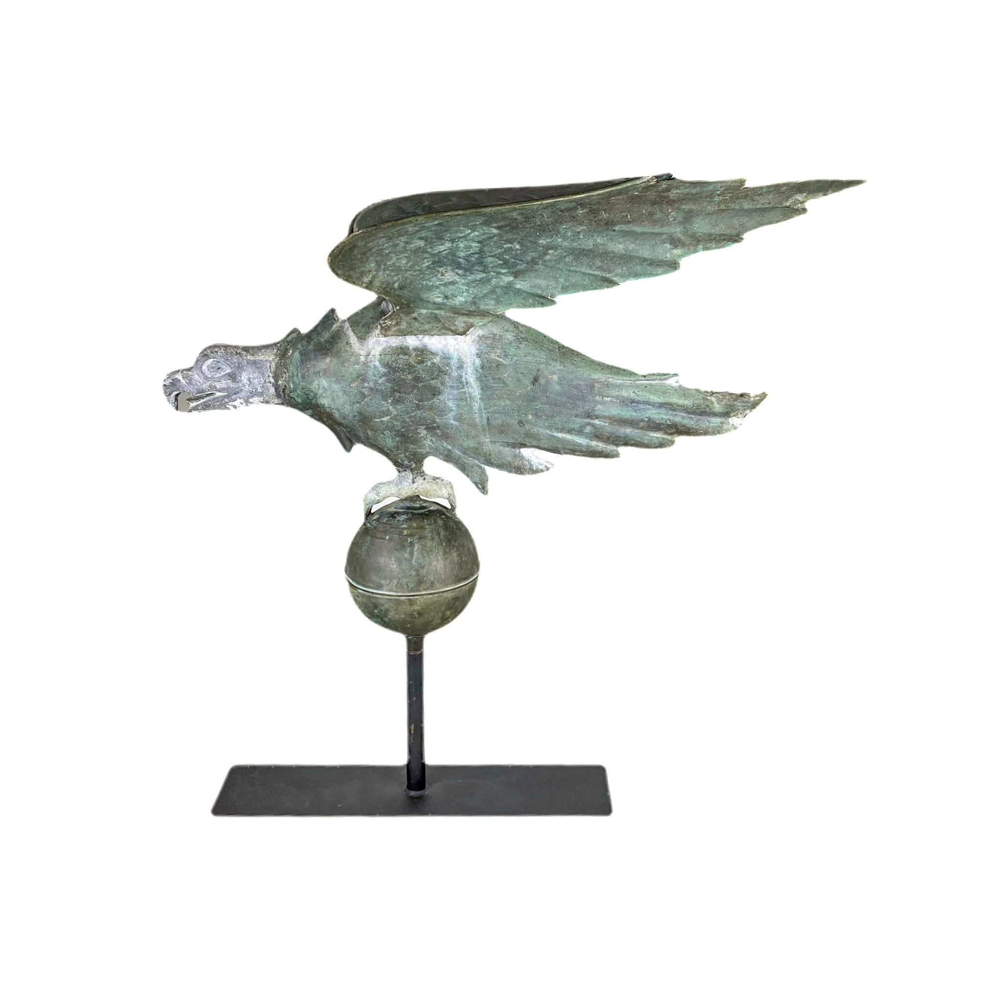 Spread wing eagle in flattened full-body form perched on a ball. Molded copper with cast zinc head and talons. Verdigris weathered surface throughout, mounted on a rectangular iron base.
Attributed to A.L Jewell & Co., Waltham, Ma.
Late 19th