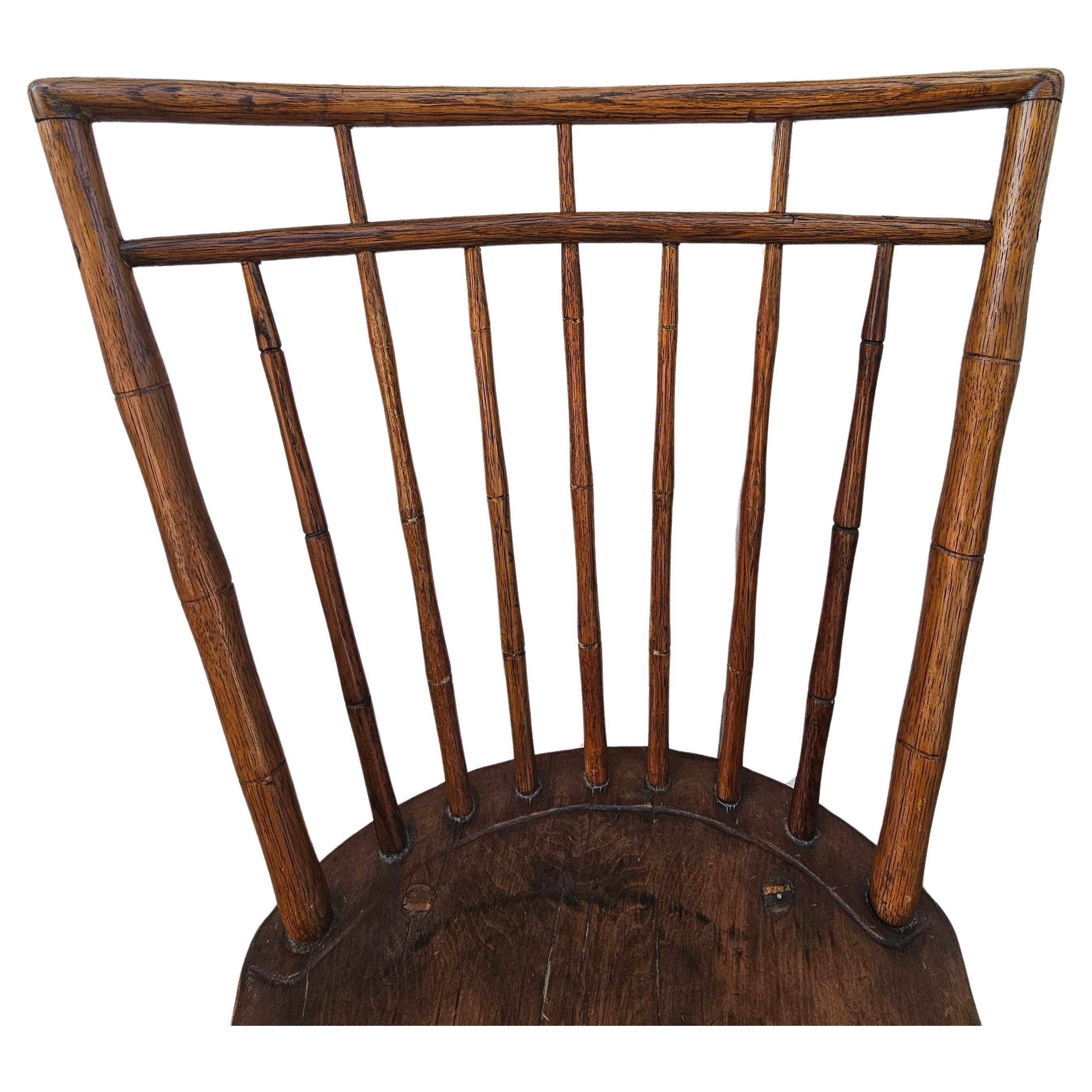 Hand-Crafted 19th Century Early American Elm Windsor Plank Chair For Sale