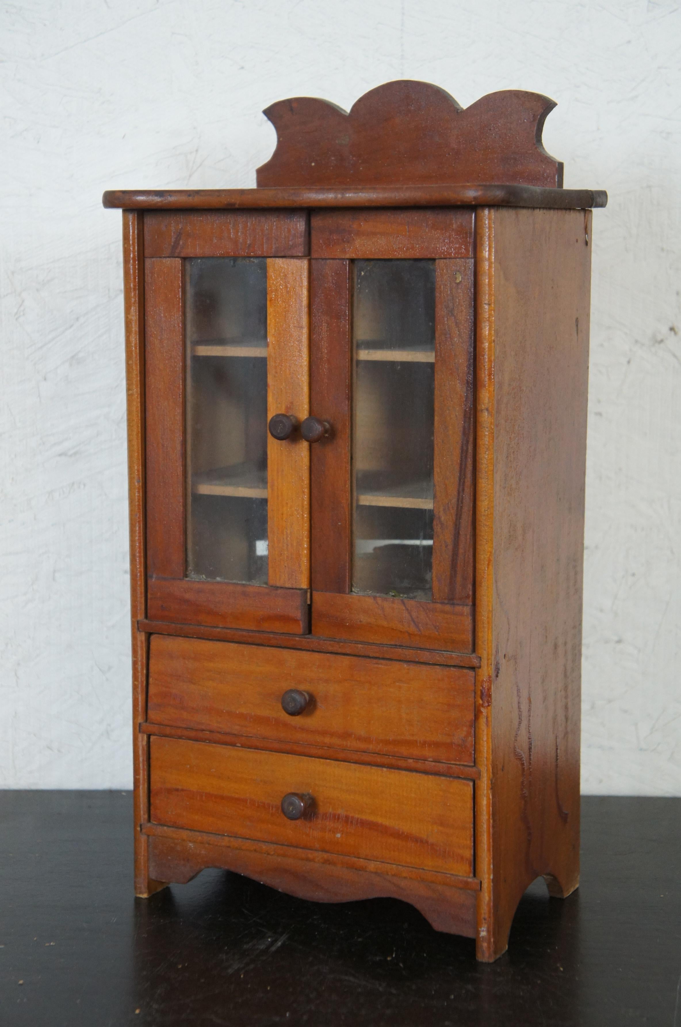 19th century artisan cupboard. Made from pine with glass front, two interior shelves and two lower drawers and backsplash.