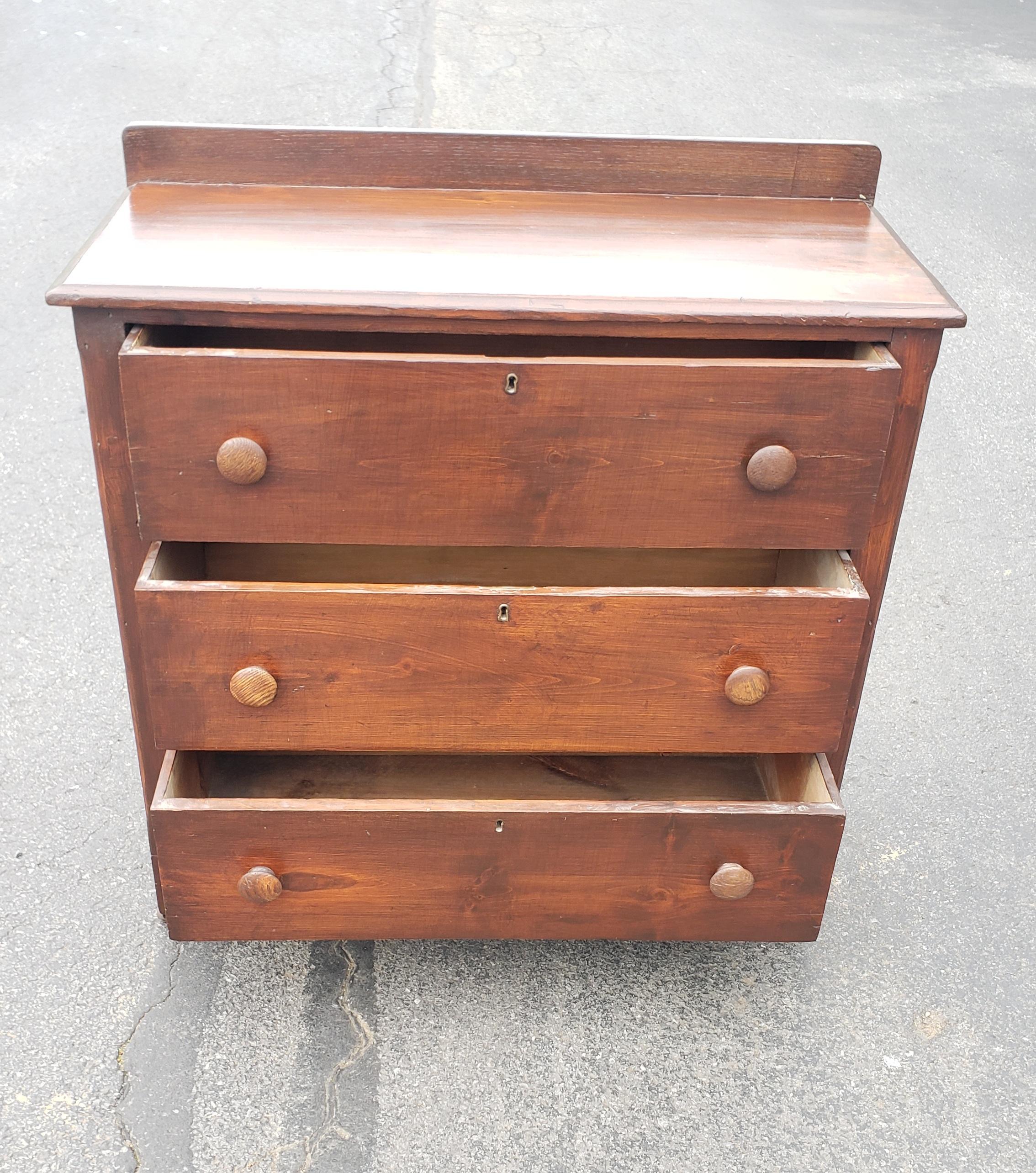 19th century early American red pine chest of drawers on wheels with pegged joints drawers. Good antique condition. Measures 35.5