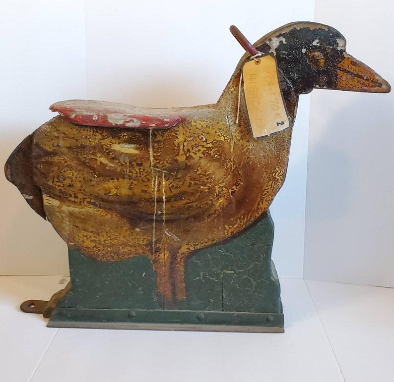 Recently acquired from a museum, we present this scarce, one of a kind, antique European early dobby platform flat style children's carousel duck (or bird) ride from the mid to late 19th century. This extremely rare and wonderfully decorative