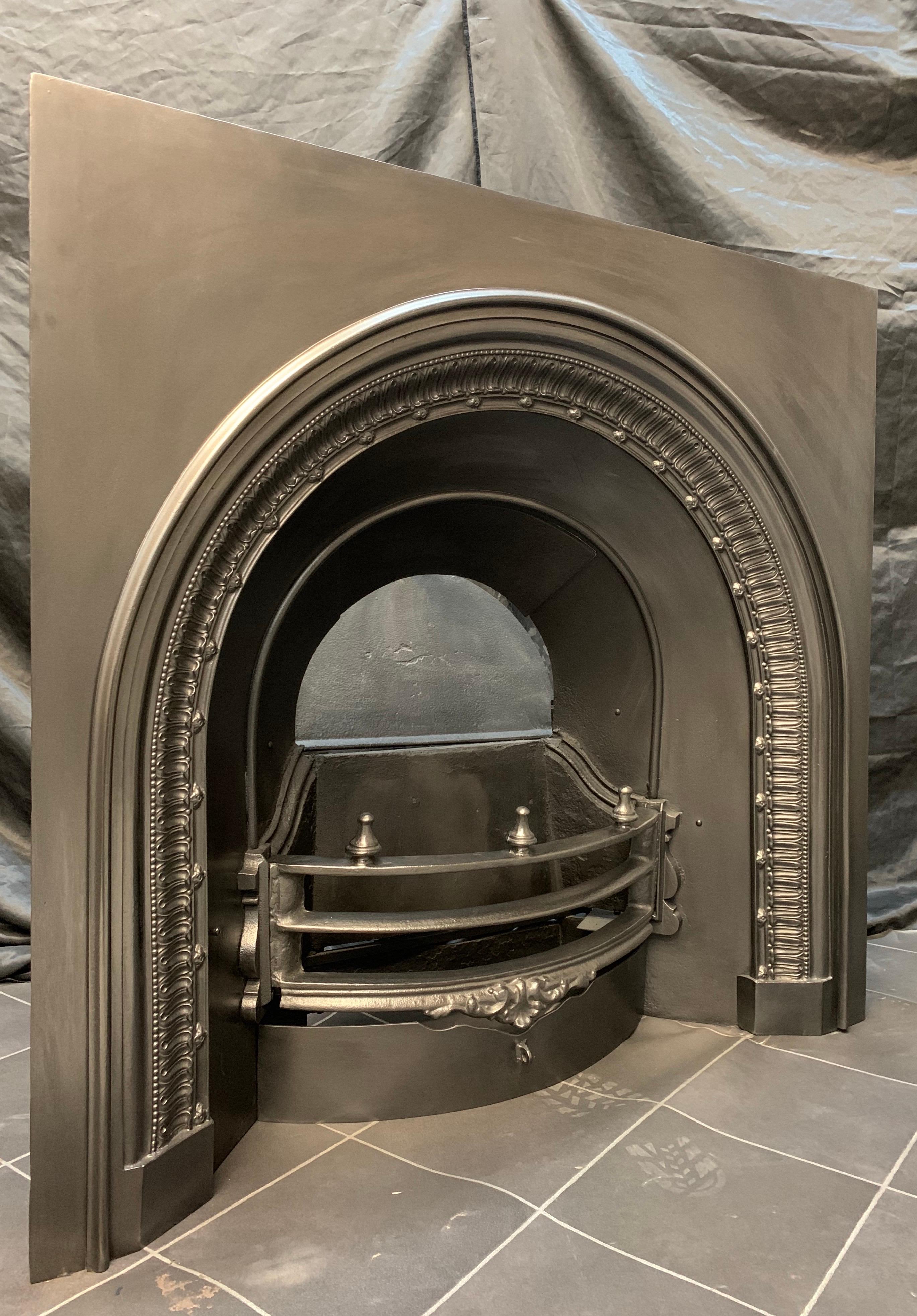A pleasing 19th century early Victorian arched cast iron insert, with original dampers. Probably Scottish, circa 1840.