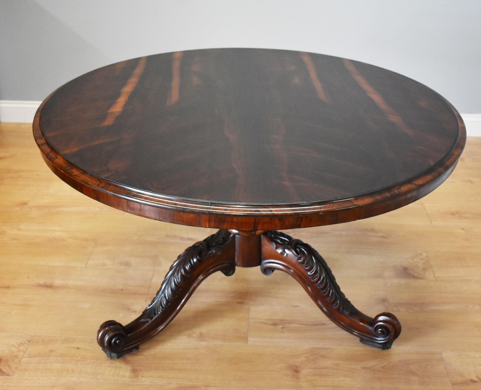 For sale is a fine quality early 19th century rosewood circular breakfast table by T Wilson of Great Queen Street, London. Having a superbly figured rosewood top, above an ornately carved base, standing on three beautifully carved legs terminating