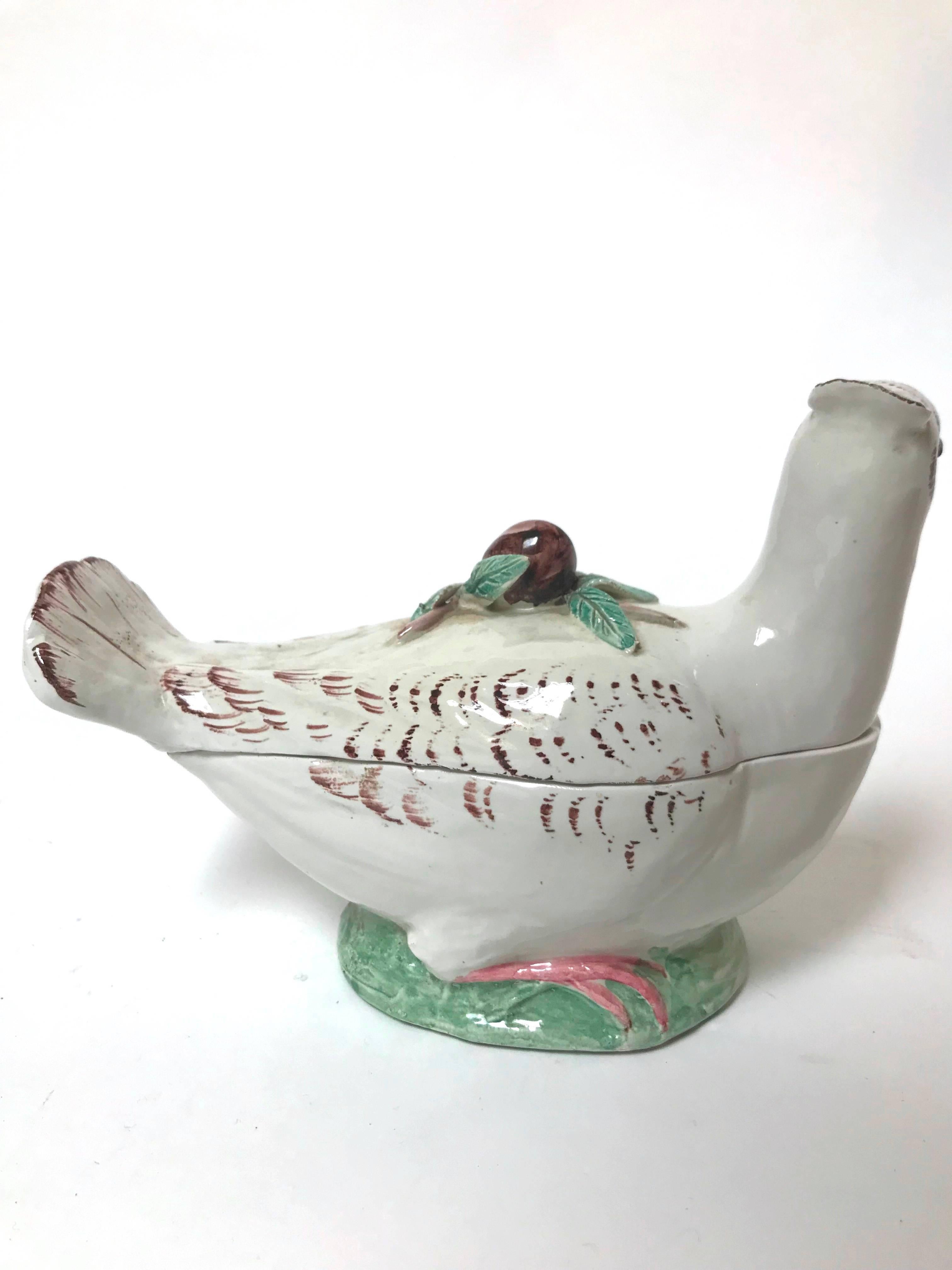 A fine bird-form earthenware tureen, possibly French, circa early-to mid-1800s, in the style of Paul Hannong of Strasbourg, naturalistically modeled as a crested game-bird, the cover applied with a plum (or olive) finial/handle, the bird posed