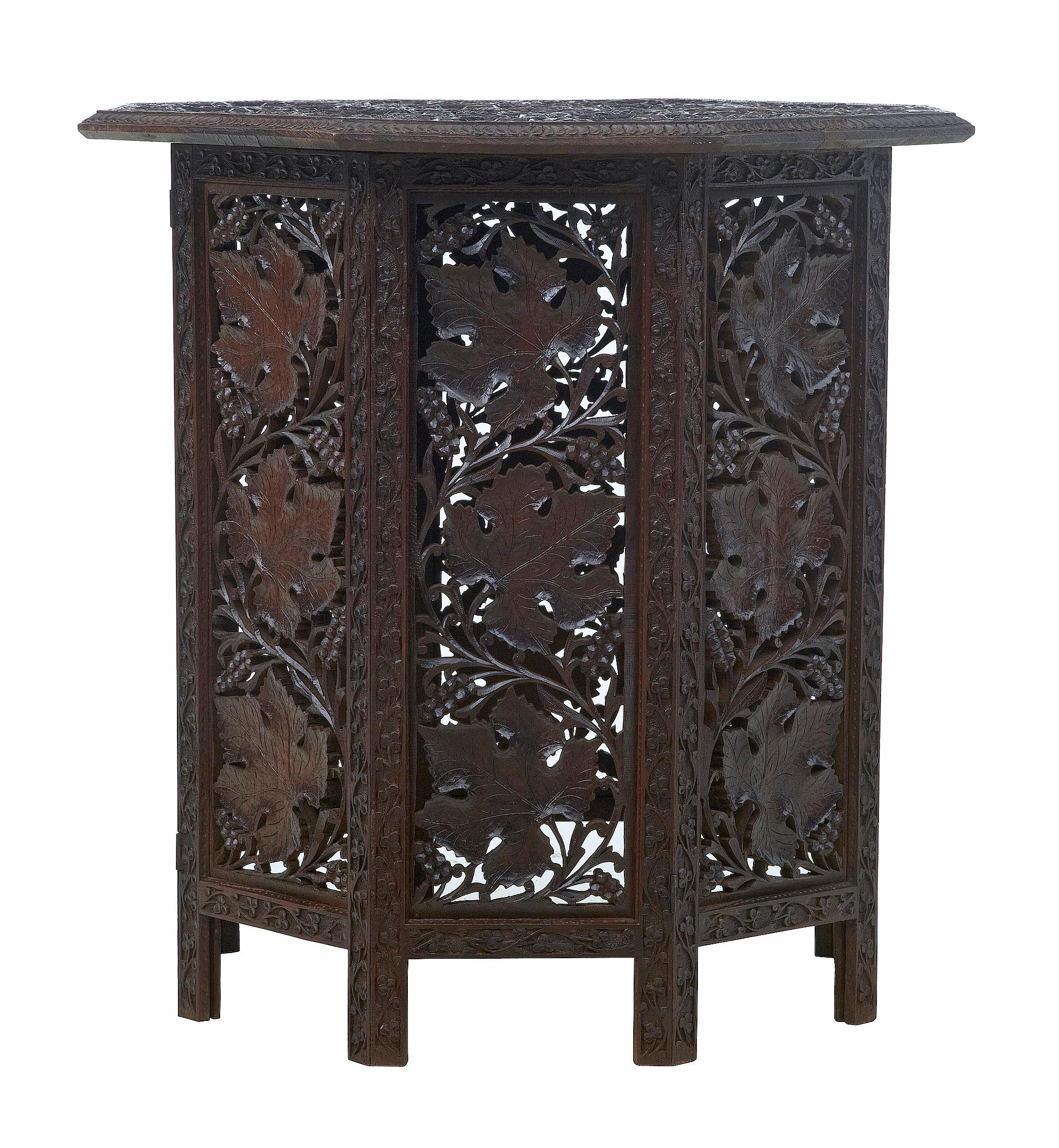 19th century Eastern hardwood carved octagonal side table, circa 1880.

Fine quality pierced and profusely carved octagonal table. Intricate carving with leaves and vines. Top is removable and sits on the base which is collapsible.

Would