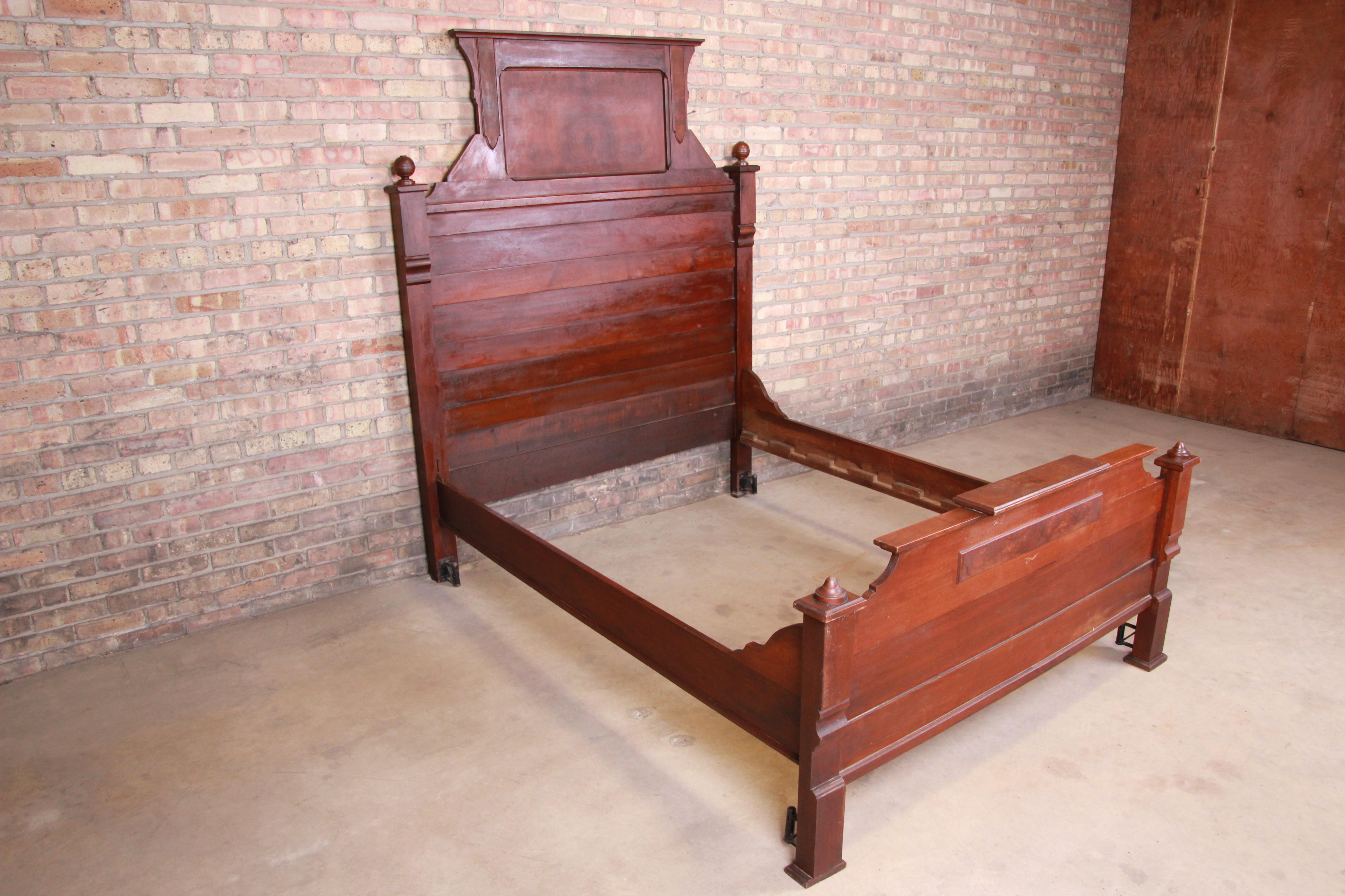 A gorgeous antique Eastlake Victorian full size bed frame

USA, circa 1860s

Solid walnut, with burled walnut panels.

Measures: 61.13