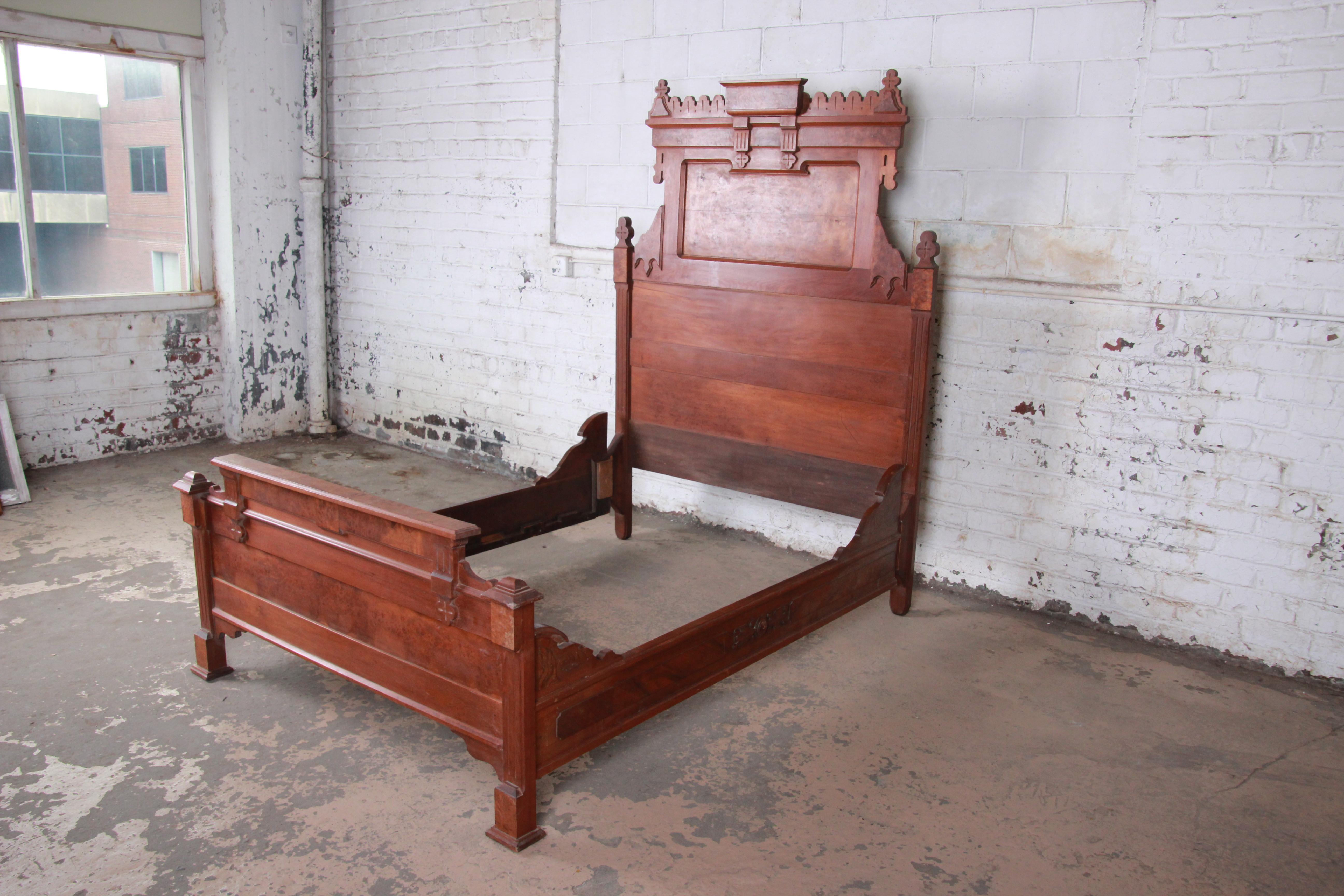 A gorgeous Victorian Eastlake carved walnut and burl wood full size bed frame

USA, circa 1880s

Measures: 59.63