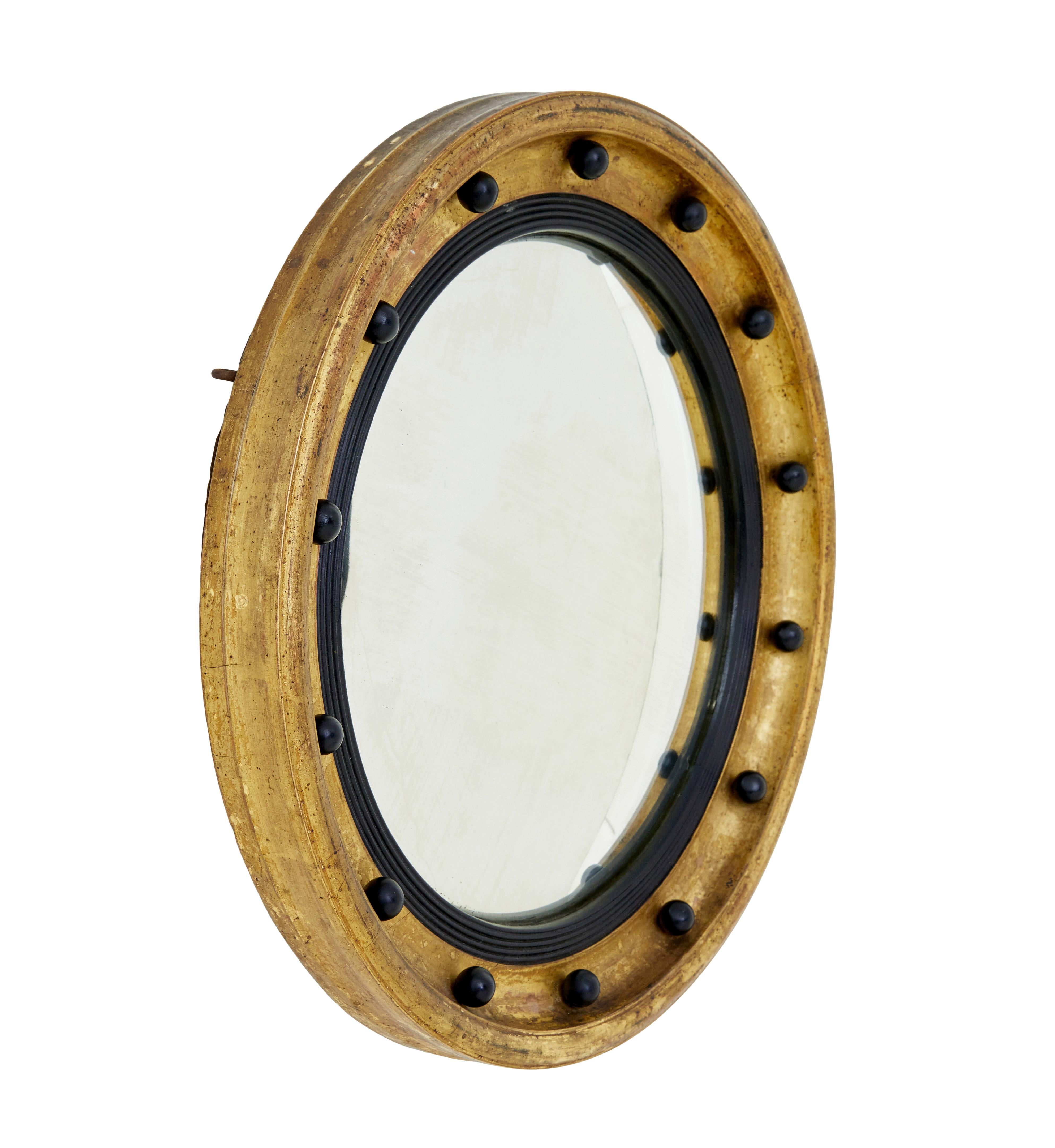 19th century ebonised and gilt convex mirror circa 1870.

Good quality circular mirror of small proportions, lending itself to being used in multiple rooms around the home.

Moulded gilt outer frame, decorated with equally space ebonised balls and