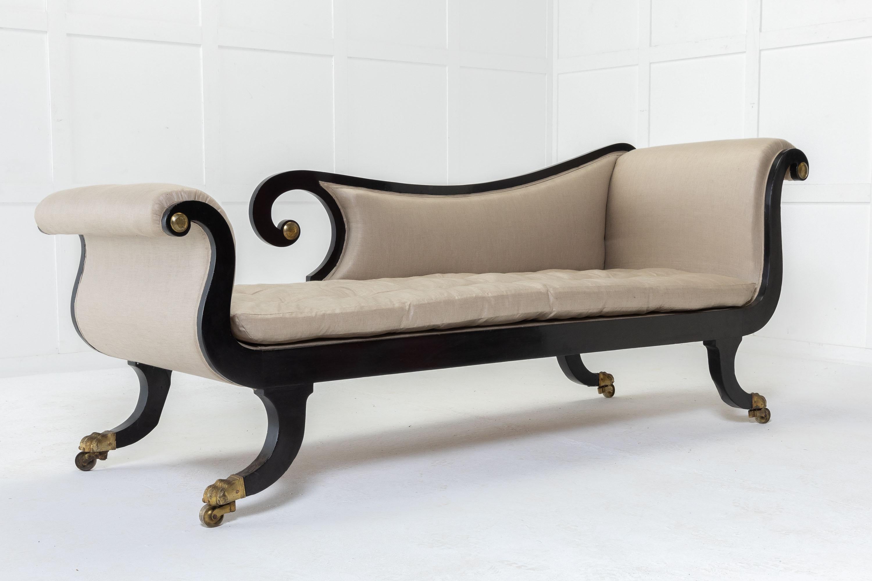 An attractive, English Regency elegantly shaped 19th Century chaise longue with flowing lines and nice proportions. Decorated with gilt on the scroll ends. Resting on well shaped sabre supports and brass castors.

Wonderful design and a very