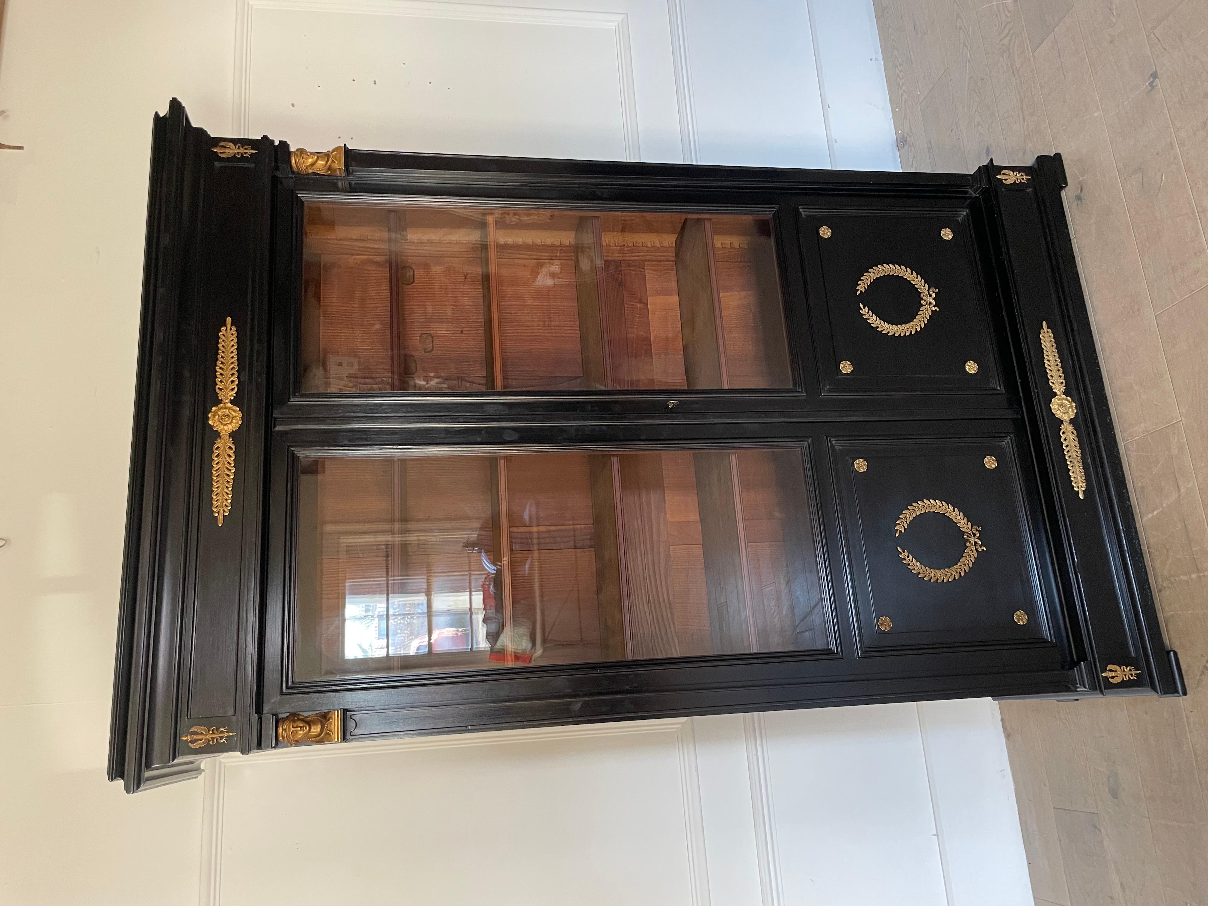 Very stylish French late 19th Century glazed bookcase. Fabulous quality original glass working lock and key 

Fully adjustable shelves , old paper labels on back boards 

Ebonised with two doors and constructed from solid mahogany.  original ormolu