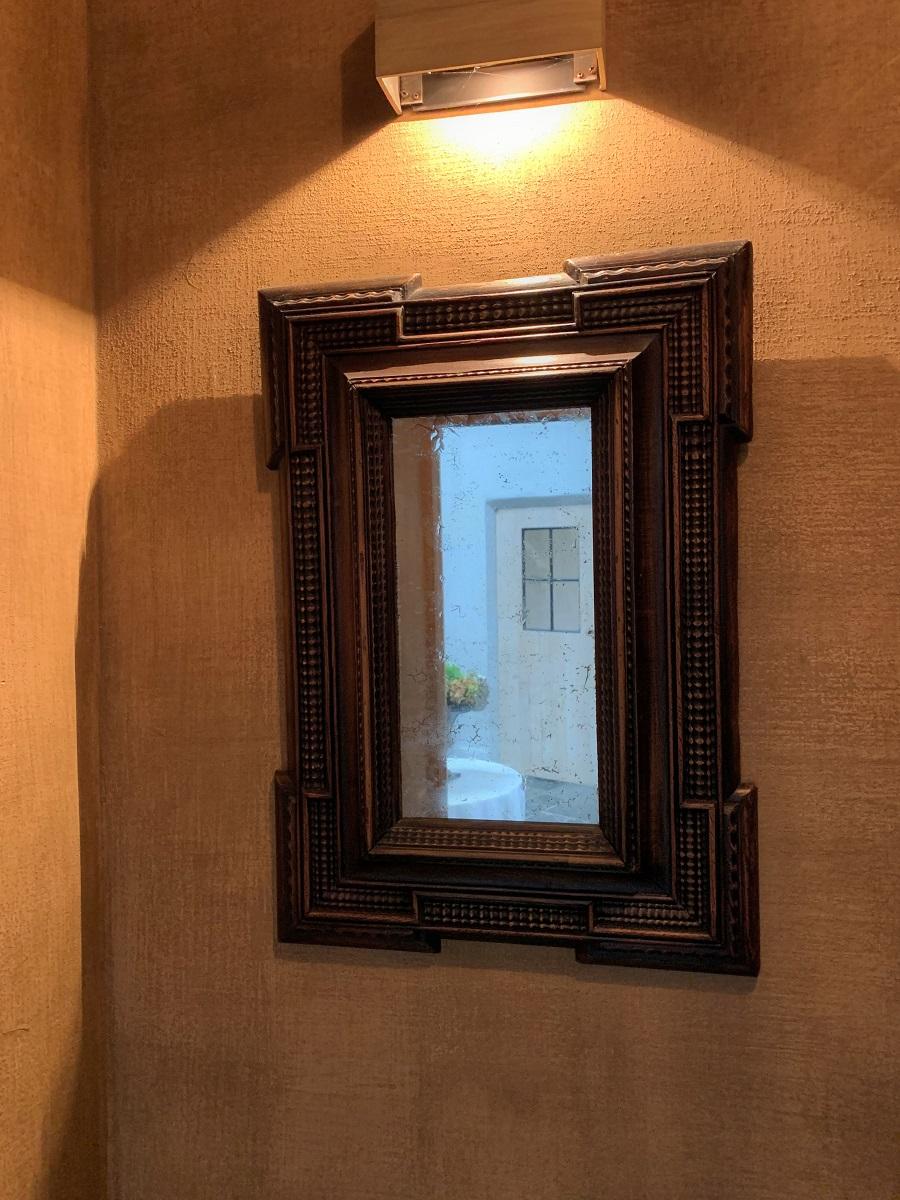A 19th century ebonized Italian mirror in classical 17th century style. Made from softwood, finely moulded and decorated. Original mirror, soft patina.