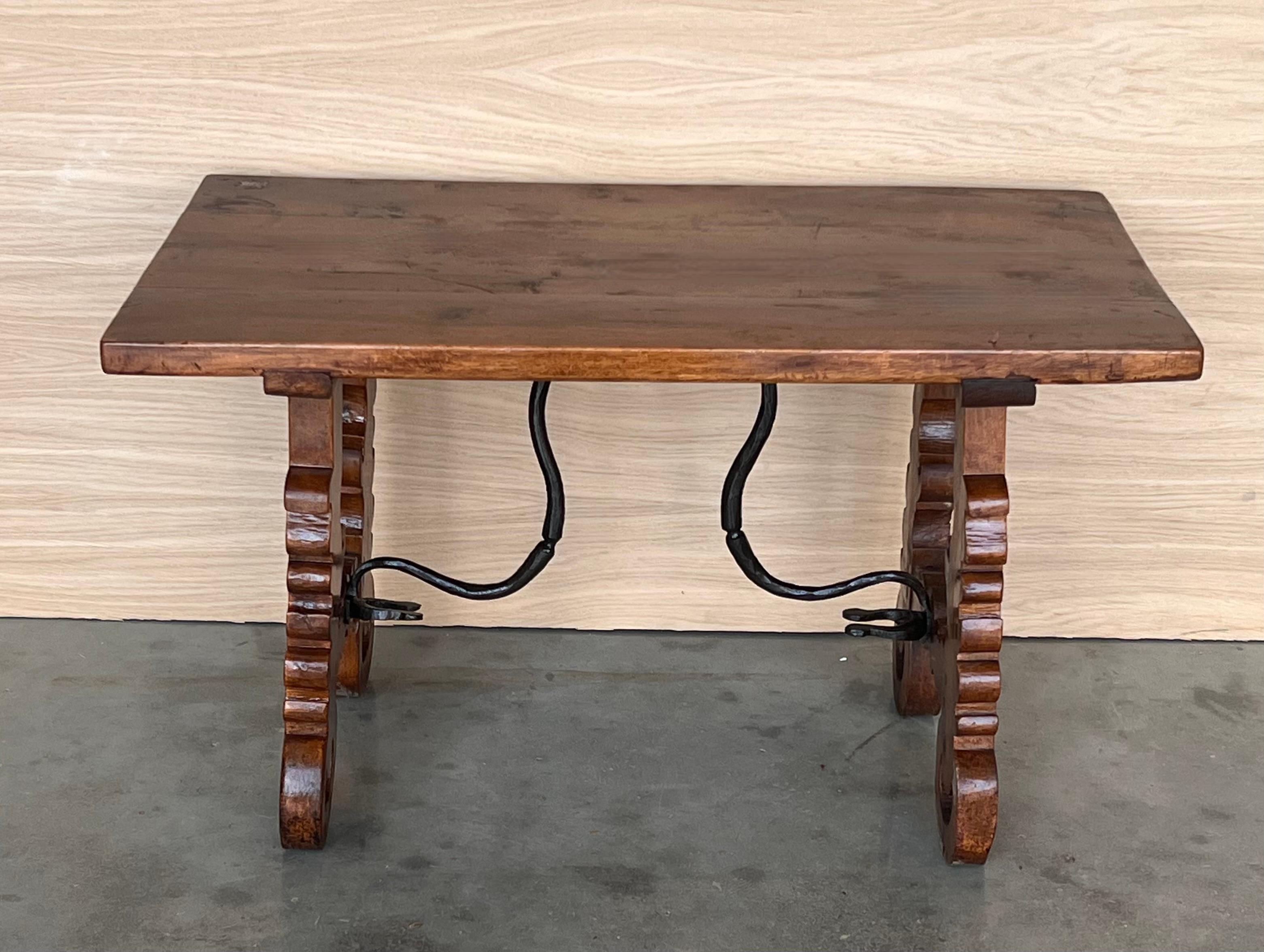 19th century Spanish trestle table in walnut. This piece has a great scale, lovely carved lyre legs and beautiful ebonized top. 
This table could be used as an end table, nightstand or side table .
Restored.