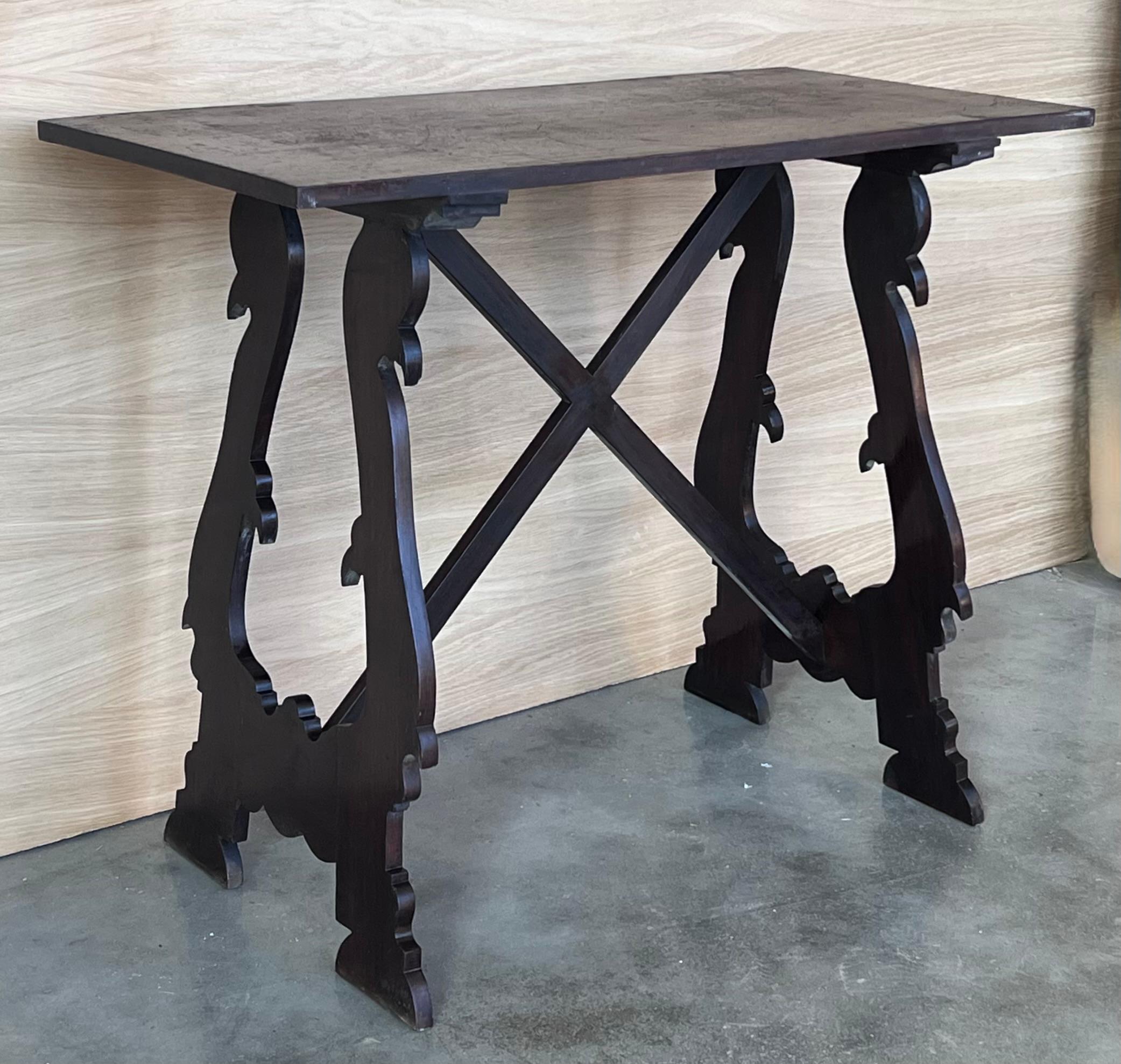 Table à tréteaux espagnole du 19e siècle en noyer. Cette pièce a une grande envergure, de jolis pieds lyre sculptés et un magnifique plateau ébonisé. 
Les tables ont des bords sculptés sur tous les côtés.
Cette table peut être utilisée comme table