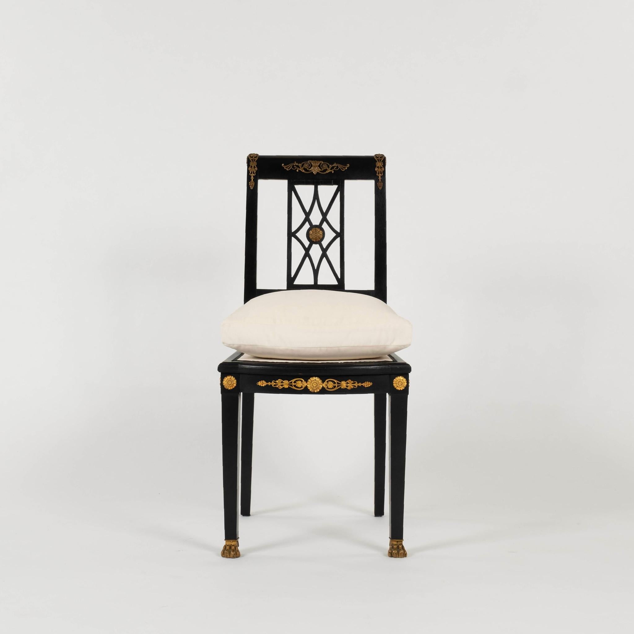 Ebonized Italian Empire style side chair featuring brass ormolu, claw feet, and a lattice-work back. This piece has a newly upholstered feather down seat cushion. 20