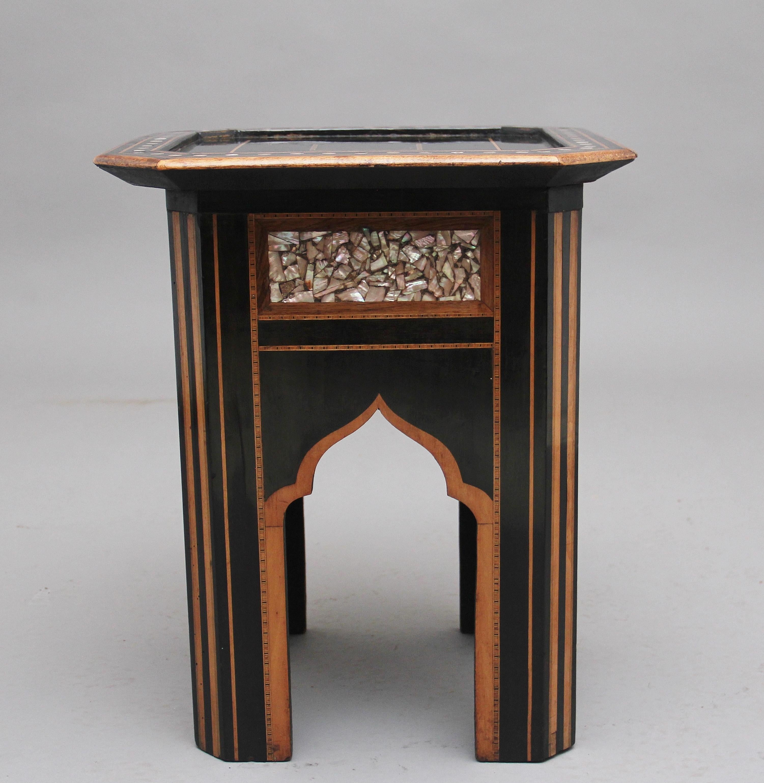 A highly decorative 19th century inlaid occasional table made from ebony and other exotic woods, the square tray top with cut corners inlaid throughout the top and having circular inlay of mother of pearl, each side of the table having rectangular