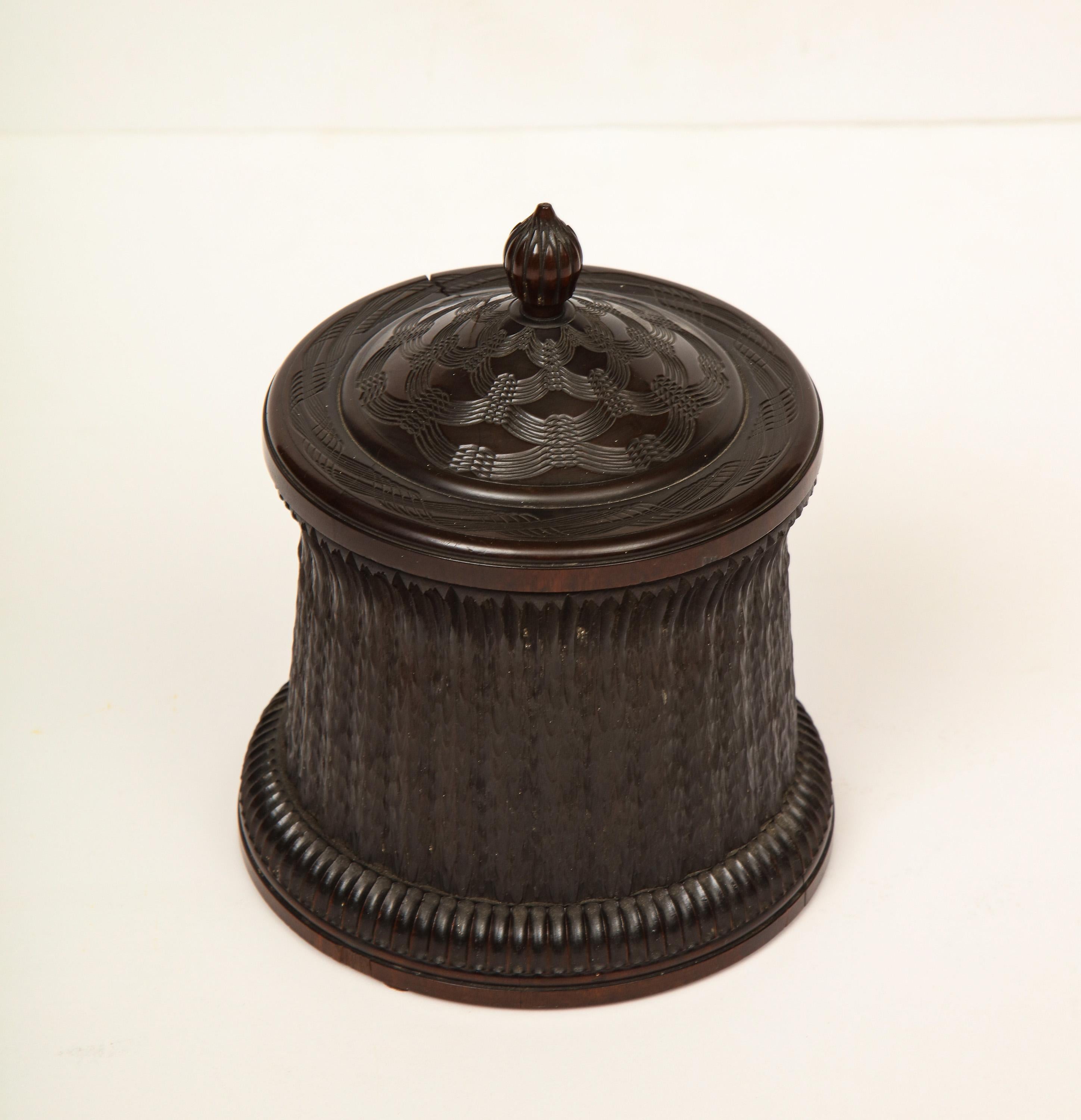 19th century, ebony, highly carved Anglo-Indian cylindrical box.