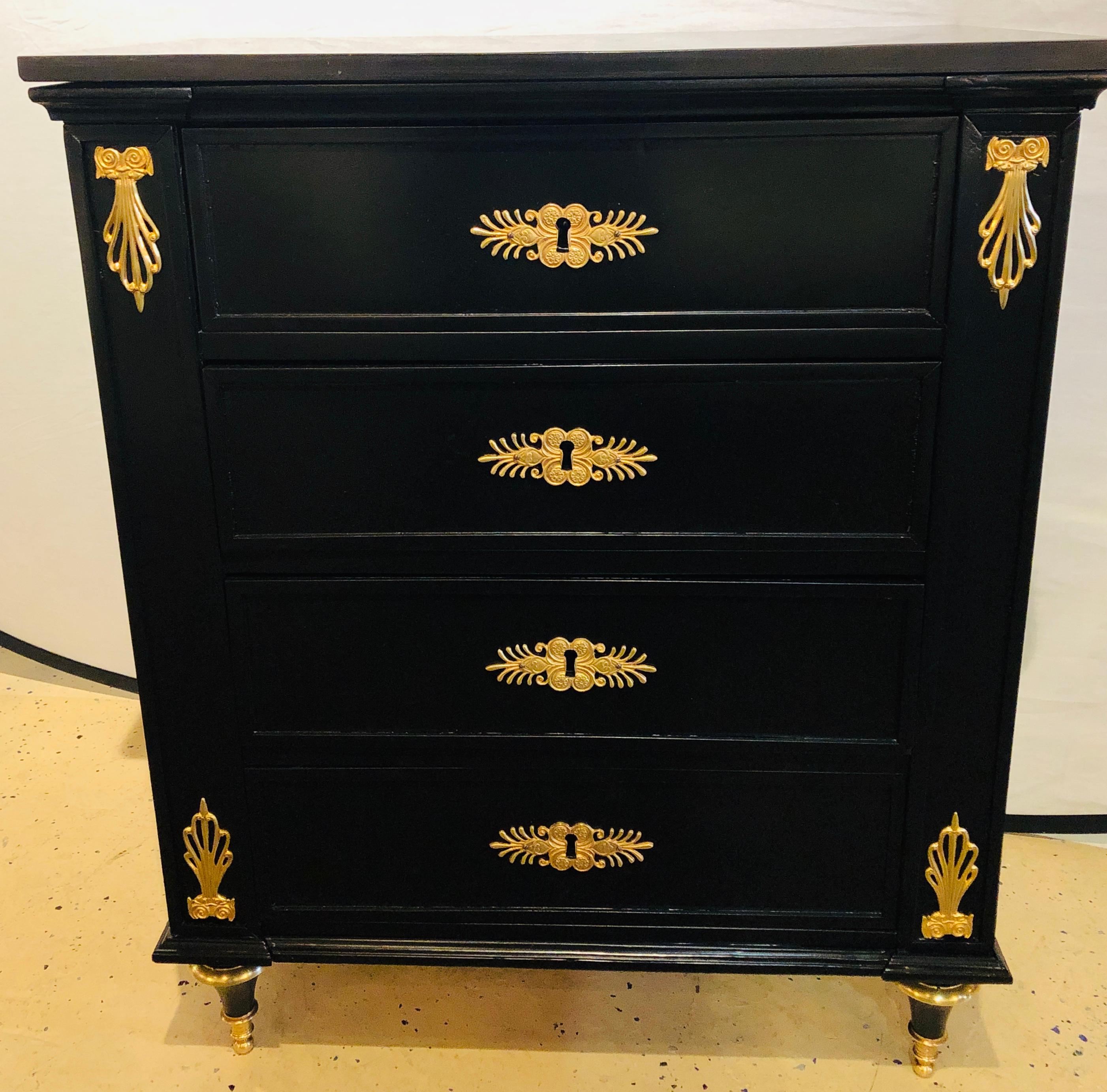 19th century ebony bronze mounted four drawer commode with black marble-top. This early commode or chest having been fully done over in an ebony finish later on in its life is simply stunning with its bronze mounts and black granite or marble