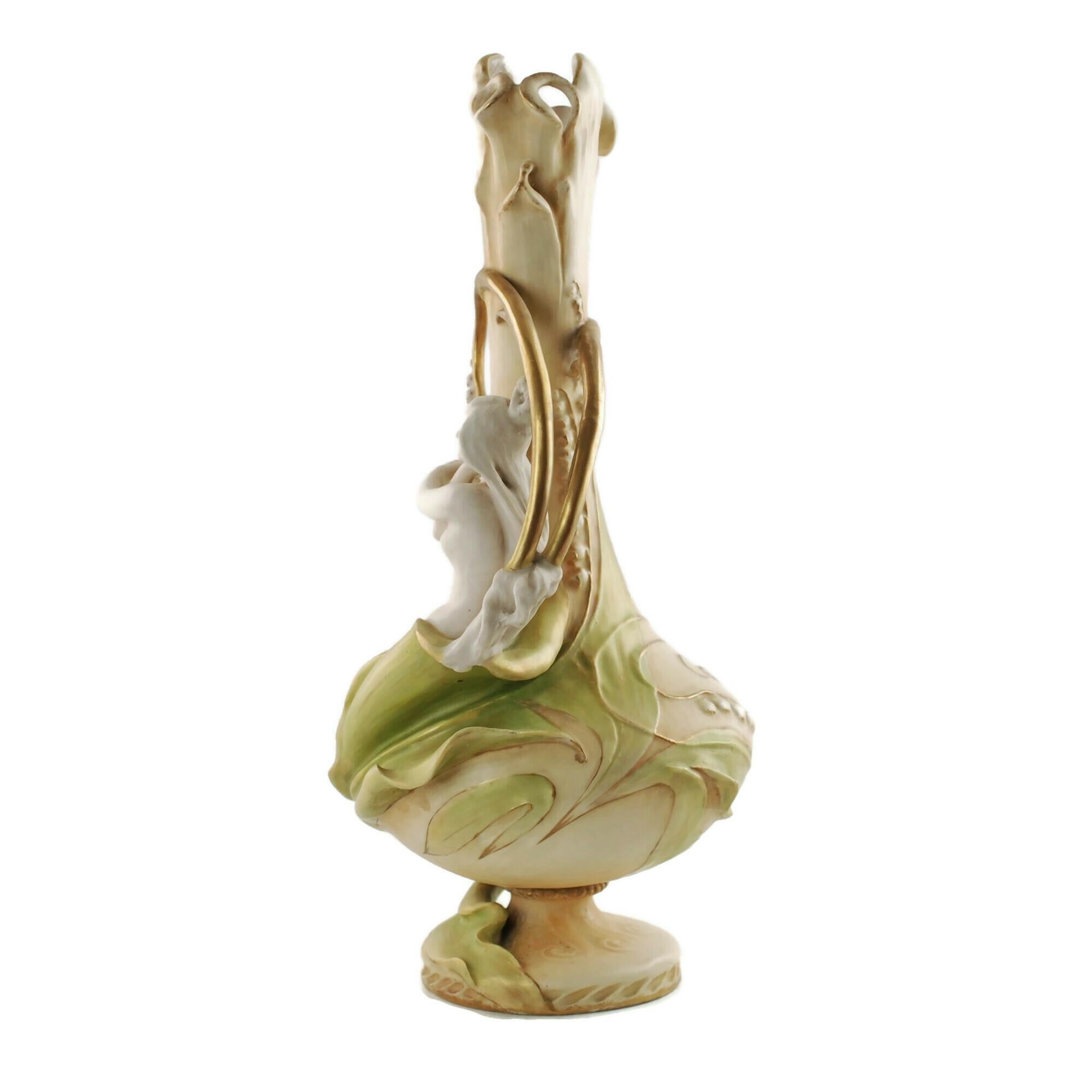 This late 19th century porcelain vase was designed by Eduard Stellmacher for Riessner, Stellmacher & Kessel Amphora of Turn-Teplitz, Bohemia. The piece has a Classic Art Nouveau form and features a dimensional nymph partially encased in the leaves