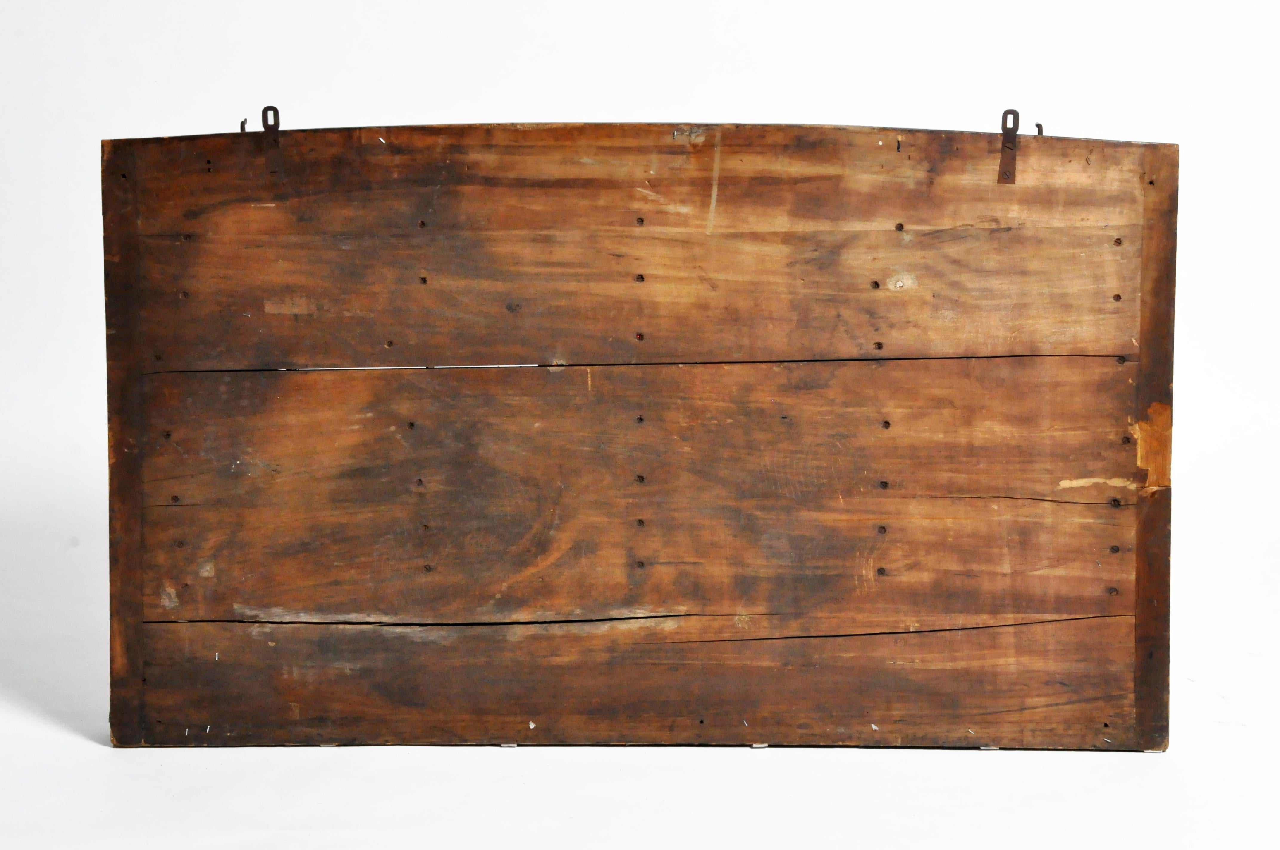 This large and colorful wall display was once used in a French classroom to hold rock and mineral samples. The piece is actually a shelf for organizing the samples according to their origins within the layers of the earth. The top tier is for