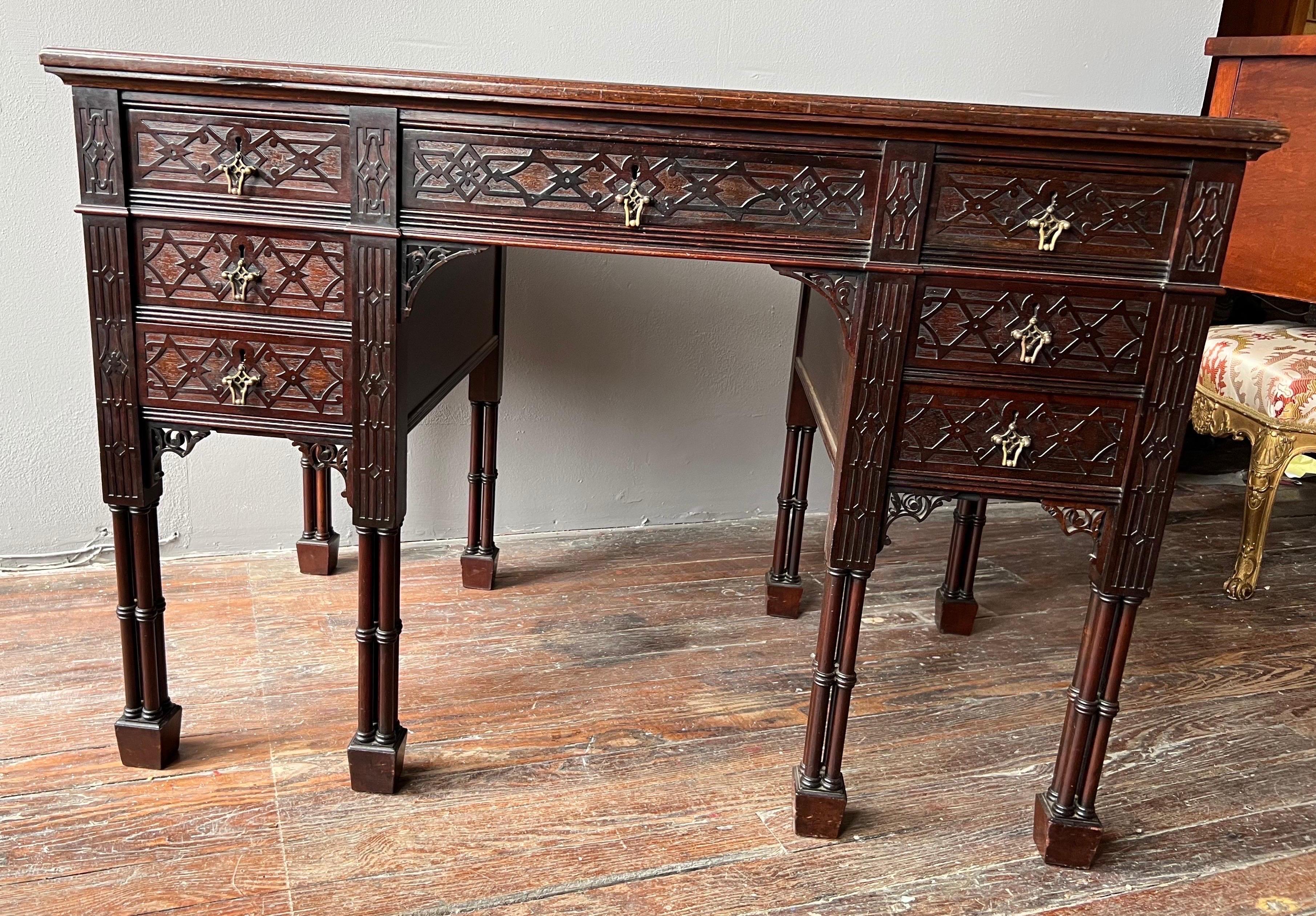 Fantastic quality 19th century Neo-Gothic leather top desk with faux bamboo cluster legs made by Edwards and Roberts. Paneled sides and back, Blind fretwork drawer fronts and the classic bamboo cluster legs. Stamped by the maker in the top of the