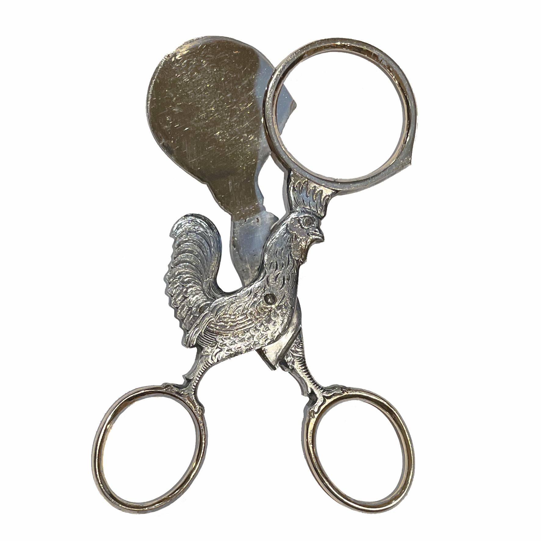 Silver and Gilt silver plate Egg scissors to cut egg shells with great refinement. A wonderful alternative to egg slicers in a very sophisticated shape of a French rooster. Lovely cristal glass red eye.
Item created in the 19th century.