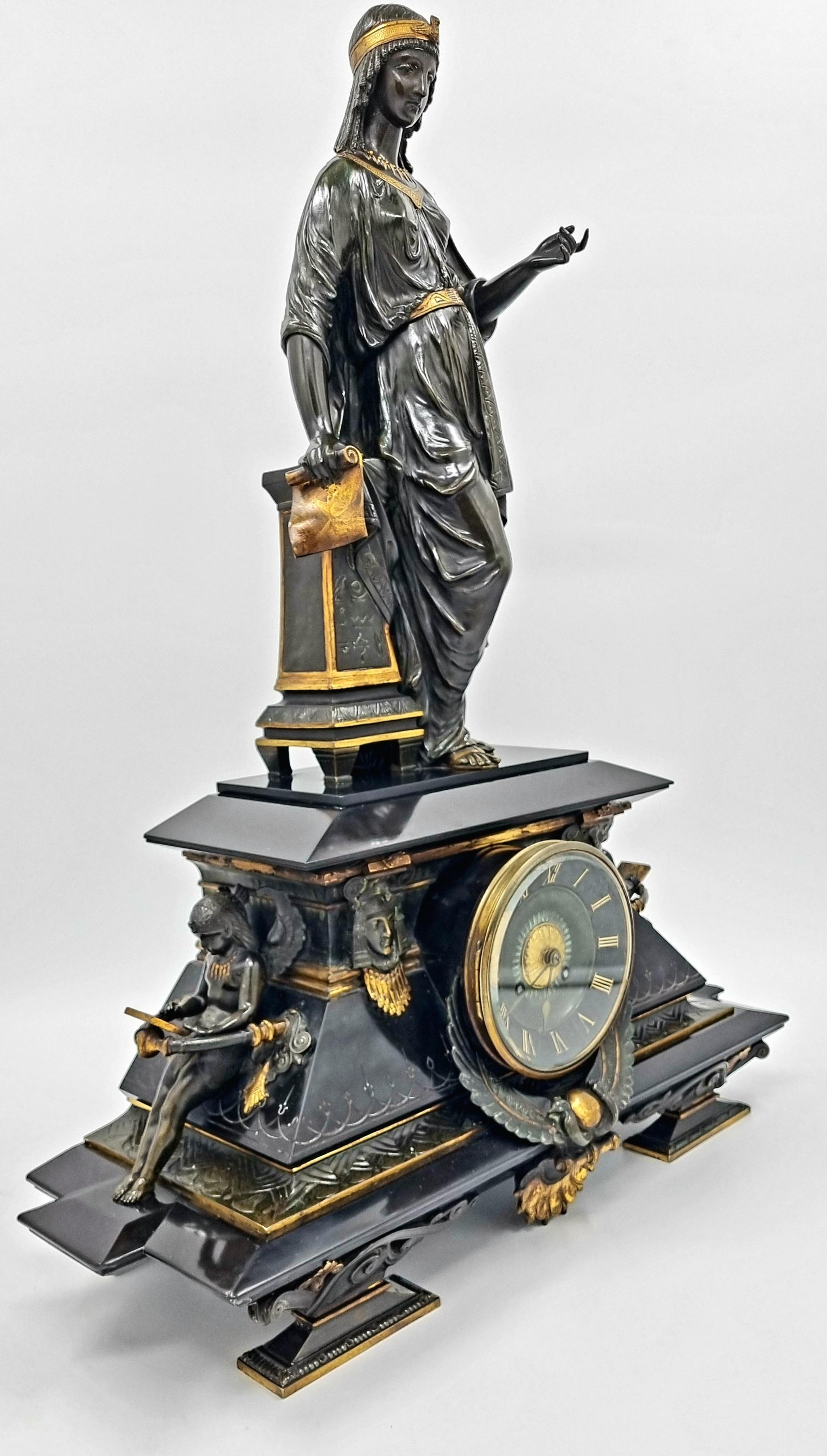 A French Egyptian Revival mantel clock, dating to the mid-19th century, is made of polished black marble and patinated bronze. The clock showcases exceptional quality and craftsmanship, using the finest materials, exuding elegance and
