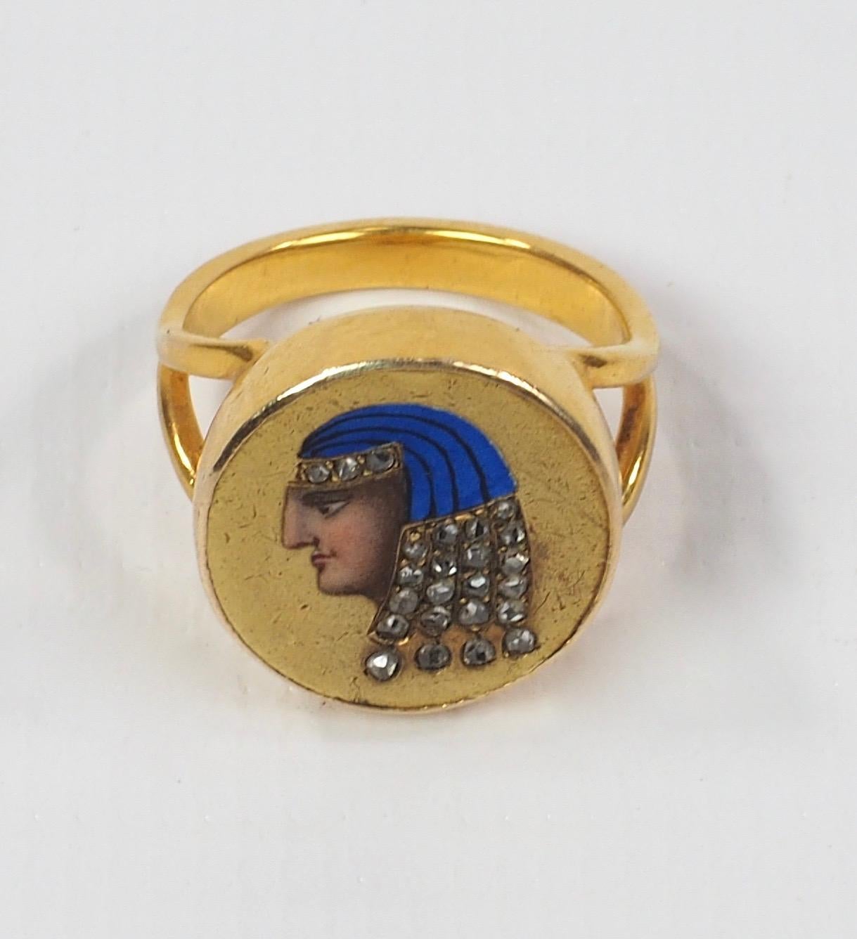 A fabulous late 19th century enamel and diamond ring depicting an Egyptian head. The ring is accented with 24 old rose-cut diamonds, gold mounted and finely enamelled. 
From the collection of Edith Weber Antique Jewelry. Jewelry from Edith Weber was