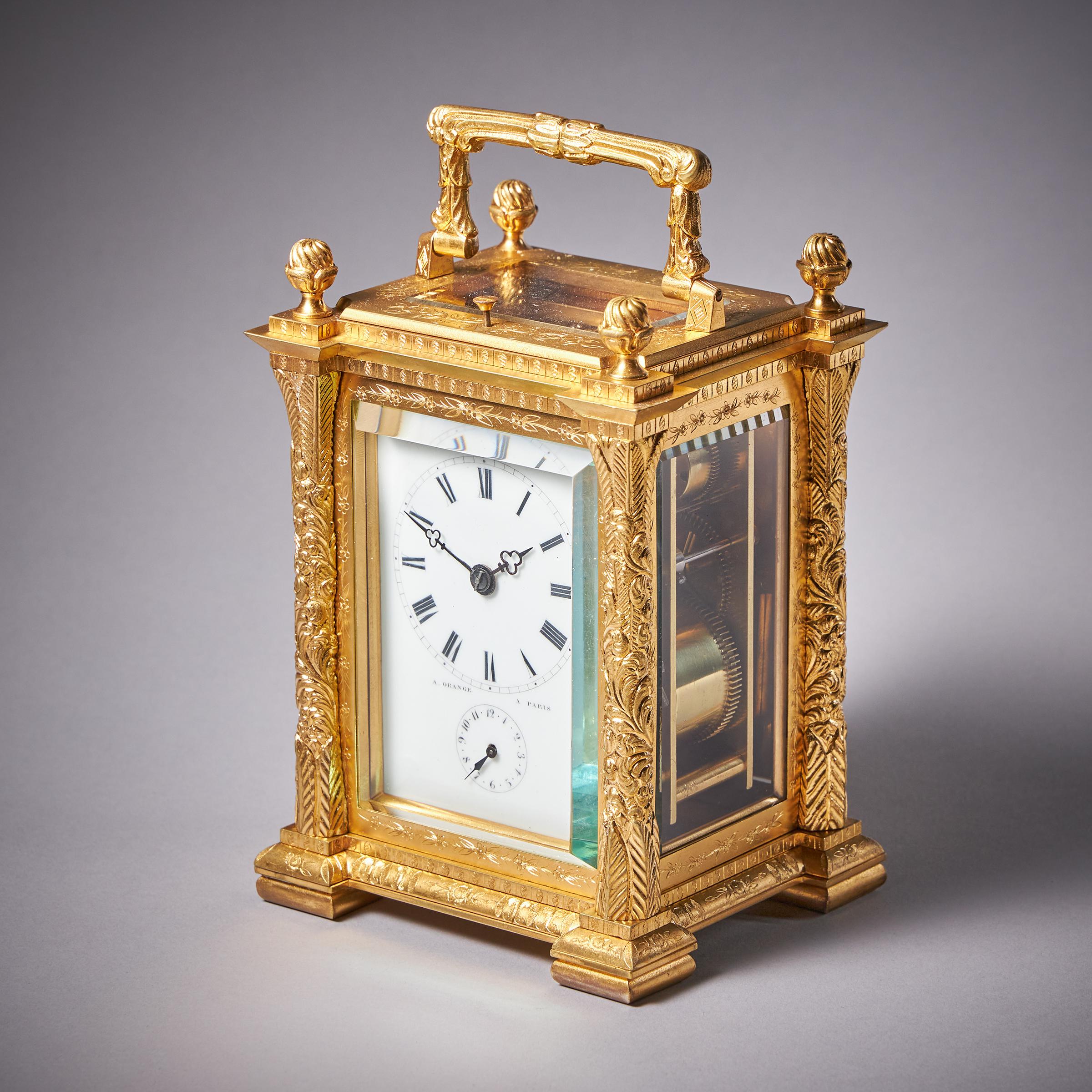 A most unusual engraved gilt-brass French carriage clock by A. Orange, c. 1860.
 
Case
The attractive beautifully engraved gilt-brass clock of unusual shape has four shaped pillars on the corners and is surmounted by four torch finials and a