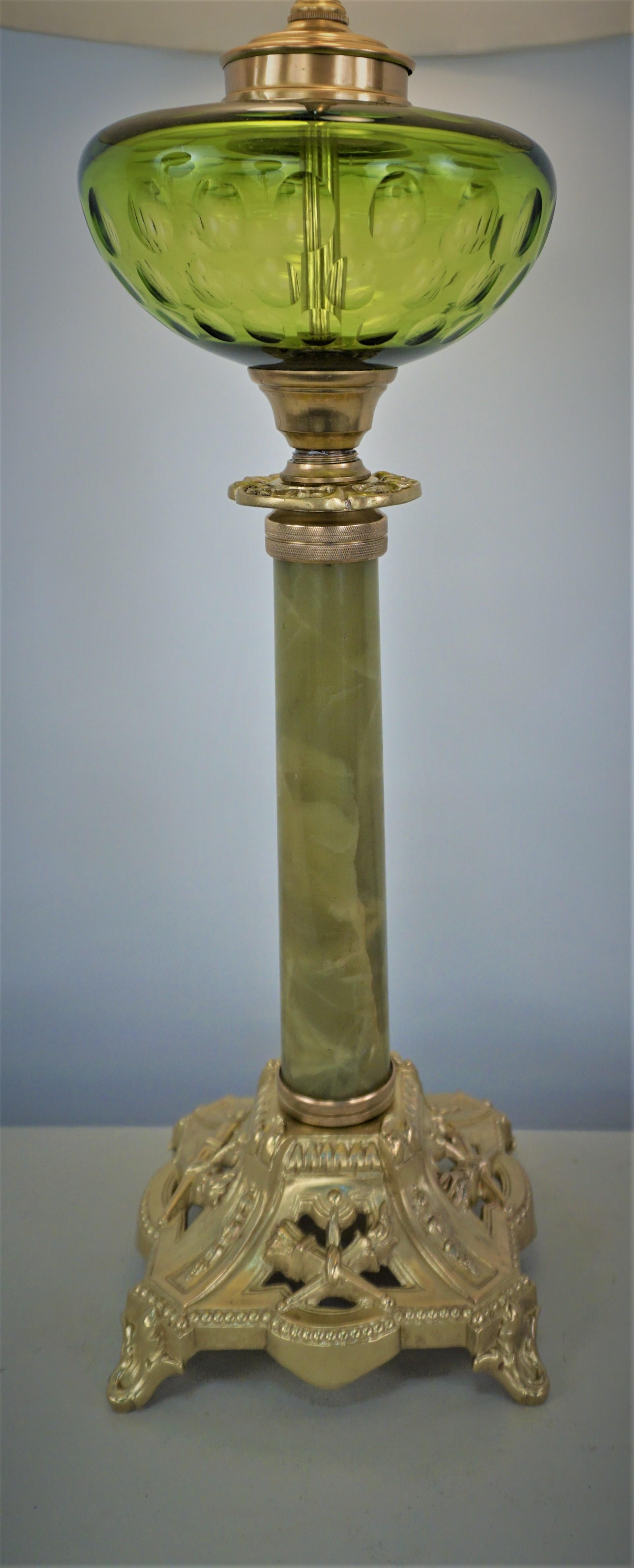 19th century bronze and green glass, onyx column oil lamp has been professionally electrified with double pull chain sockets and fitted with box pleat silk lampshade.