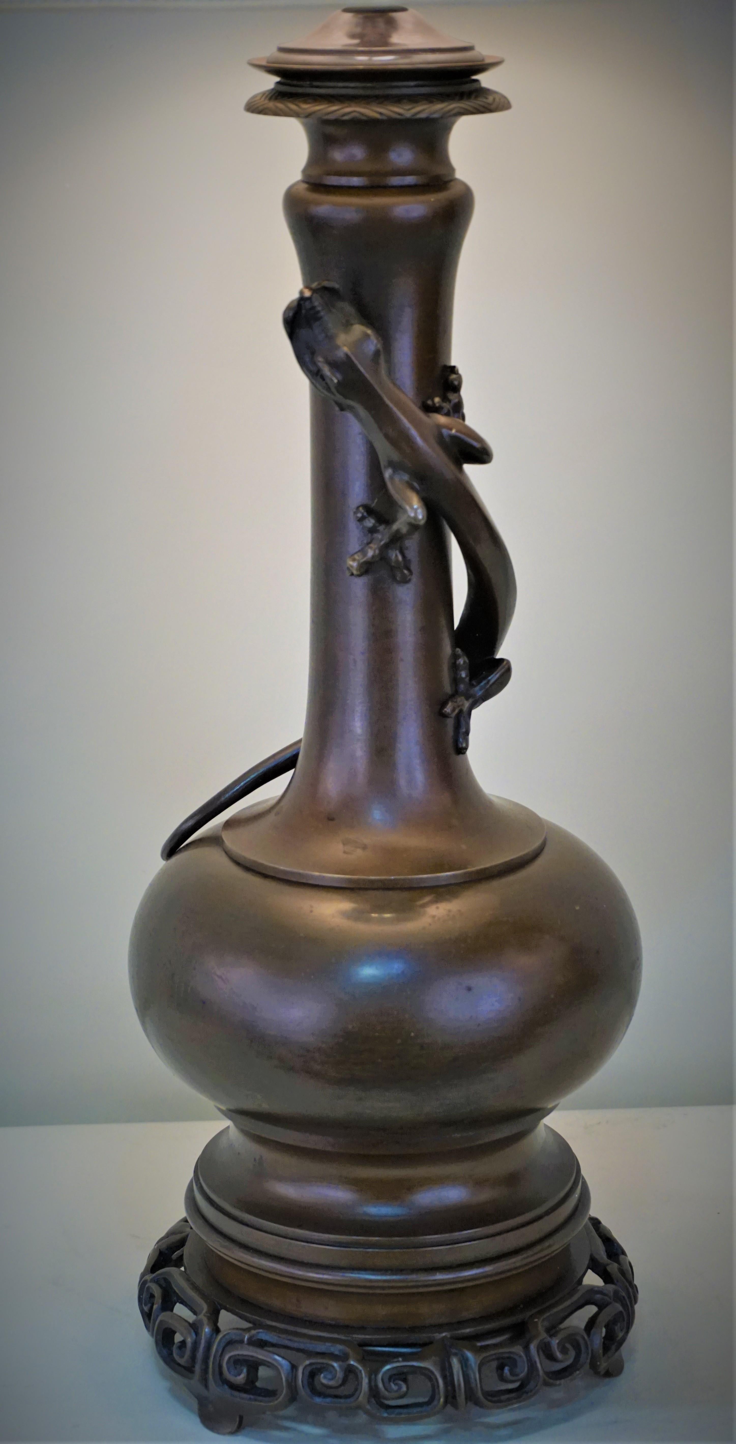 Wonderful two-color bronze with legend Lizard is associated with the dream time moving upward on the lamp. This original oil lamp have been electrified and fitted with silk lampshades.