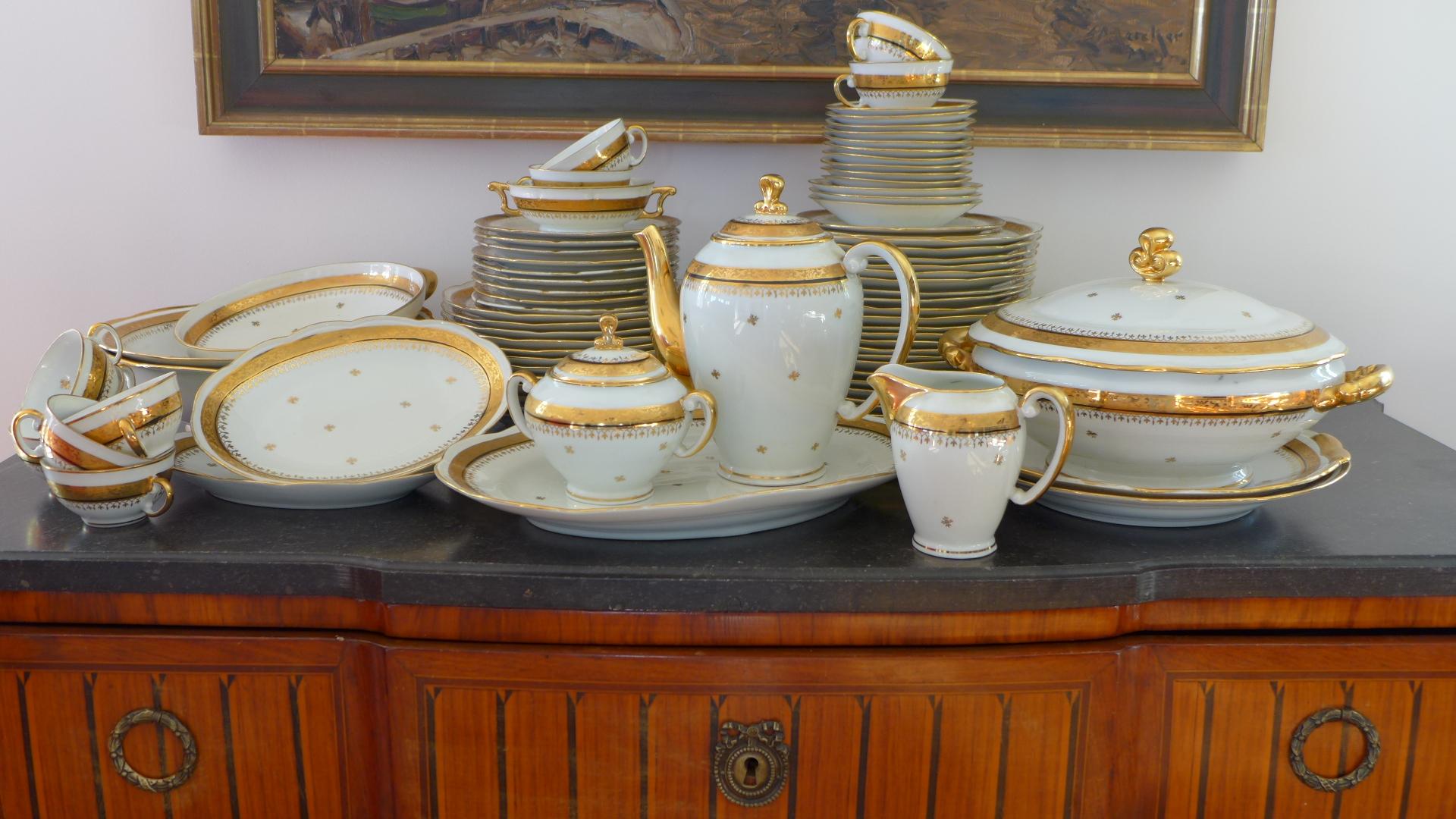 A very elegant 68 pieces French Limoges table service for 12 people, completed with its coffee/tea service for six people in very good condition with additional nice pieces. White brilliant porcelain with floral decoration on the edges in fine gold