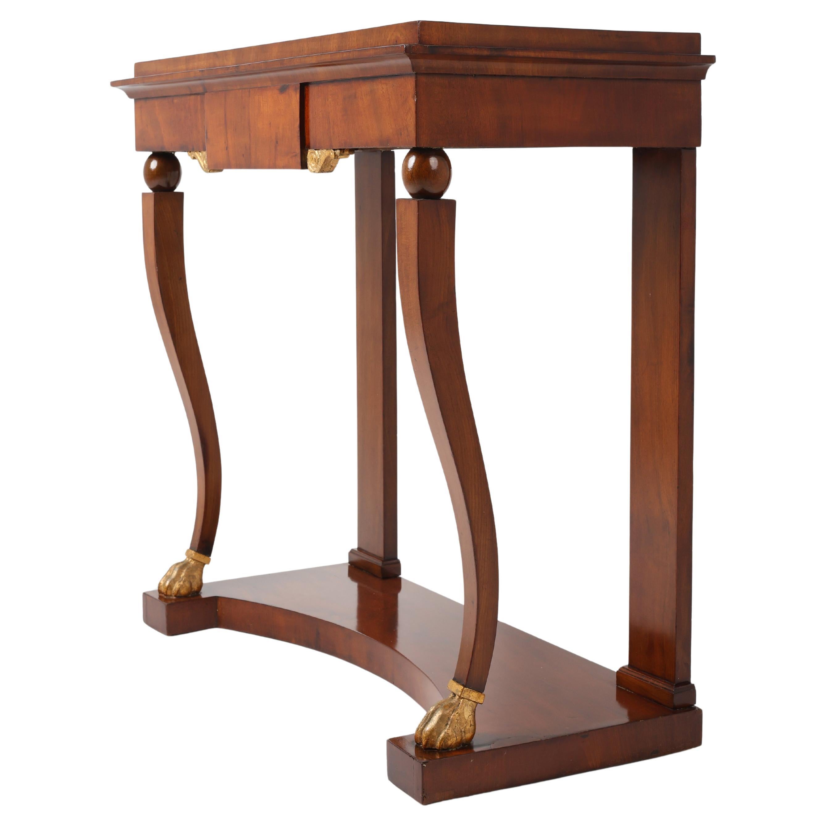 Very Elegant Mahogany-Veneered Console Table

A refined and elegant console, veneered in mahogany, featuring a single drawer integrated into the apron. The case rests on four sculptural legs, the front pair shaped as volutes and accented with gilded