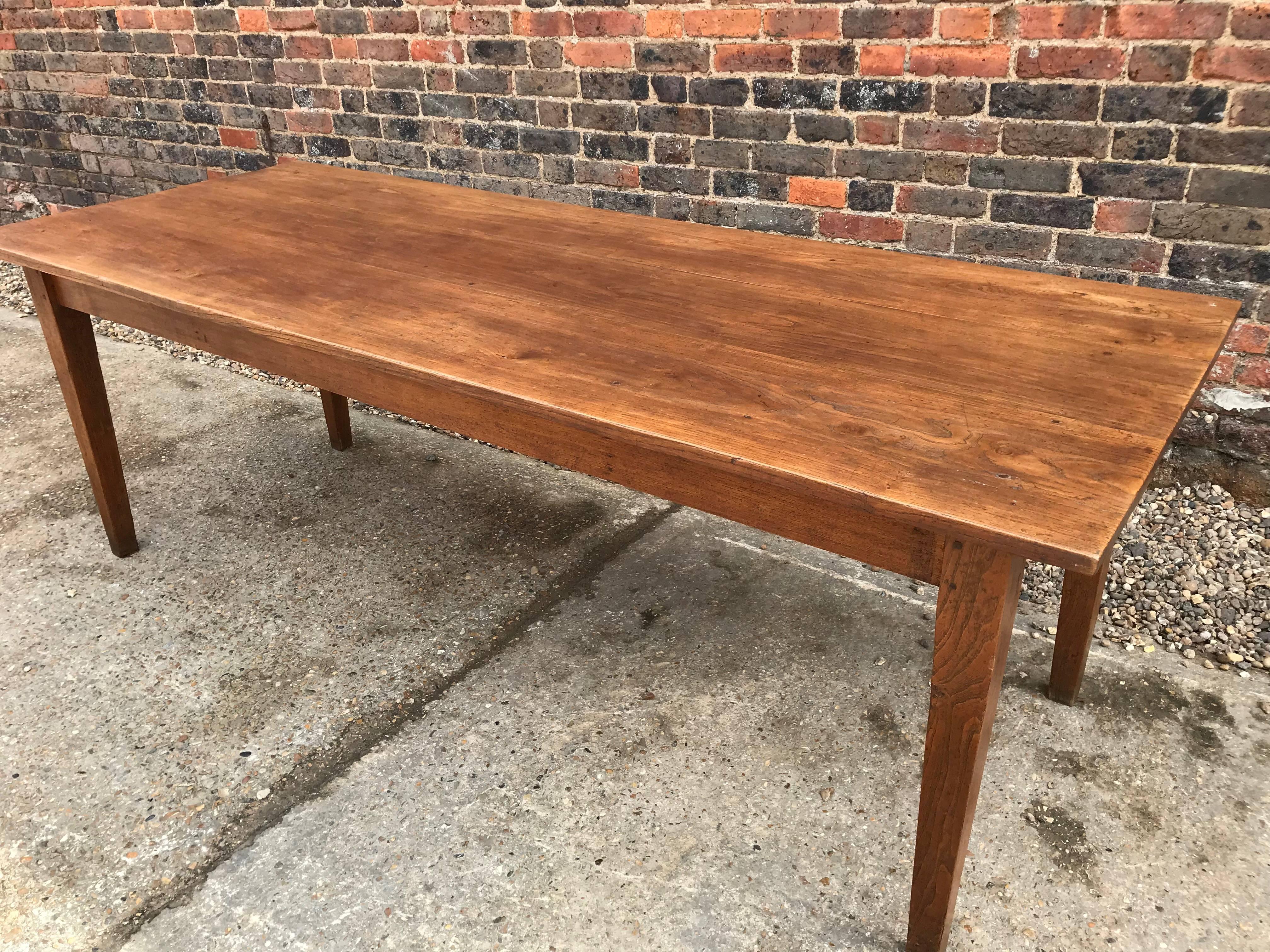 19th century elm antique French farmhouse table with tapered legs. French dining farmhouse table with lovely top and sits on four tapered legs. The table has a end drawer. Lovely patination and colour. Very simplet design with elegant